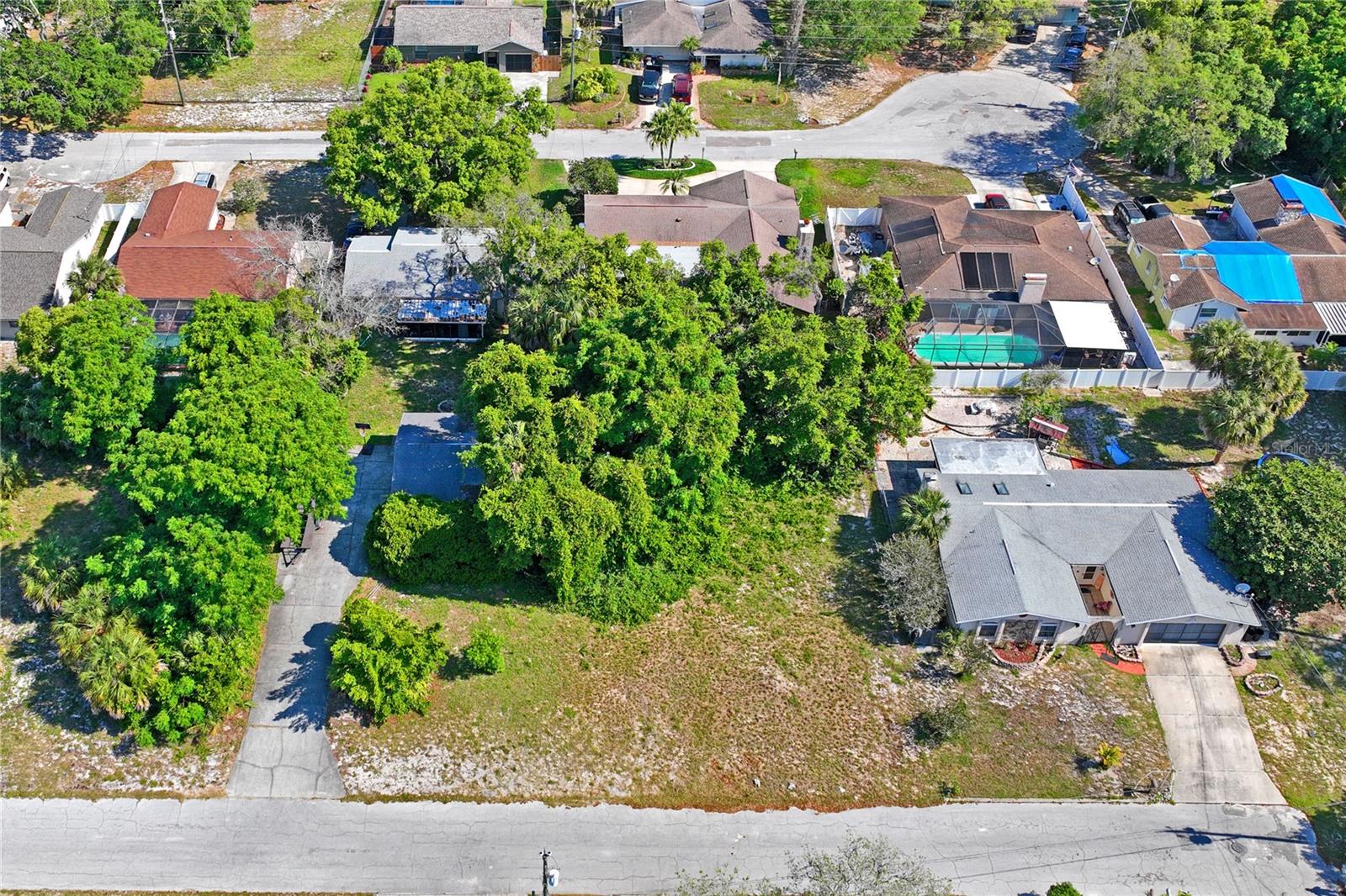 This lot is situated in a beautiful waterfront community next to a peaceful dead end, with a convenient boat ramp within the community. Water enthusiasts will appreciate easy access to the water for a day of recreational activities. It is located near various amenities such as shopping centers, restaurants, schools, hospital, parks, and so much more. Immerse yourself in the vibrant lifestyle of the Sunshine State, with the beautiful Hudson Beach just a few miles away, where you can witness breathtaking sunsets over the water. Don't miss the chance to own this prime piece of real estate.