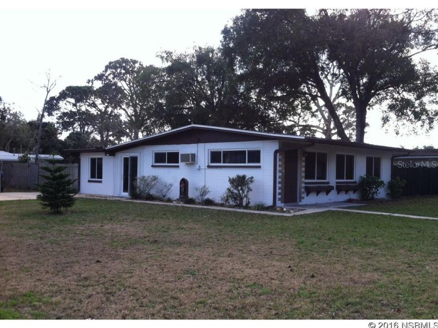 Need a little more elbow room than "cookie cutter" subdivisions allow these days? No HOA here and plenty of room to "stretch" your legs. Have 2 or 4 legged "kids" you'd like to keep safe or need a place to store your boat or camper in your own private fenced in back yard? If boating is your hobby, conveniently located just across US-1 is the new public boat ramp, making it easy for a day of intracoastal fun! This 3 Bdrm, 1 bath concrete block home has an open concept for entertaining OR keeping an eye on the little ones. And if you do have children, basically around the corner are multi sporting facilities, suitable for even grown-ups too! Shingle roof replaced in 2006. A/C replaced in 2013 w/10 yr labor warranty. Energy saving, double paned, insulated vinyl windows (and sliding doors) are 6 yrs old. Hot water tank 3 yrs new with refrigerator, kitchen sink, dryer about 5 yrs old and kitchen cabinets and counter upgraded a few years before the roof. Stove and washer are a bit older, but clean as a whistle and work like a charm! Bedrooms could use a little updating but move-in ready. Out back, there's a concrete patio just waiting for a screened enclosure as well as a huge fire pit and koi pond for those soothing southern evenings. If you're handy and need xtra work space, look no further than this oversized backyard with not 1 but count 'em 3 utility bldgs that remain. The 2 aluminum bldgs (10'x20' ea) are pristine, "6 yrs new" and manufactured by Lark and Pro Built Inc. Lastly, there's a well built wooden deck for sunning, framed by a beachy mural, setting the mood for exactly what New Smyrna Beach is all about! So c'mon, isn't it about time you found your own slice of paradise! ;Water: City