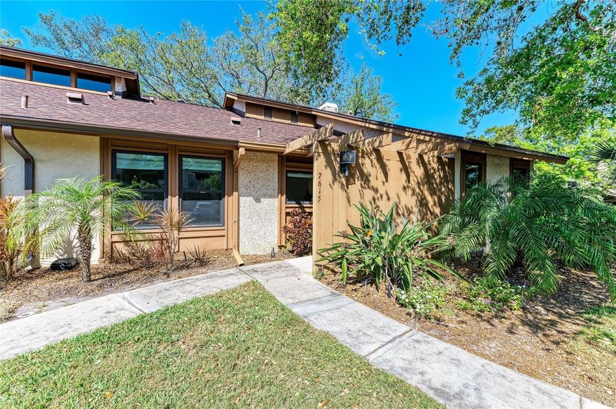 Just minutes from the beaches of Anna Maria Island, this stunning end-unit villa is located in the highly desirable Pine Bay Forest community and offers exceptional privacy, natural light, and tranquil views. Enjoy peaceful mornings and unforgettable sunsets from the screened lanai, overlooking lush tropical landscaping and serene surroundings—an ideal setting for relaxing or entertaining.

This immaculate 3-bedroom, 2-bath residence features all new windows(2024), the sought-after Hearthstone floor plan and is located in an X flood zone, where flooding is unlikely. The property was unaffected by recent hurricanes, with no flooding or damage. Upon entry, gleaming hardwood floors and vaulted cedar ceilings in the spacious Great Room create a bright, airy atmosphere that flows seamlessly into the lanai, highlighting the home’s indoor-outdoor living.

The split floor plan provides privacy for owners and guests, while the updated kitchen offers wood cabinetry and granite countertops with ample space for daily living or hosting. The generous primary suite features his-and-hers walk-in closets, direct access to the lanai, and an en-suite bathroom with dual sinks. Additional highlights include a dedicated laundry room with washer, dryer, and extra storage.

Residents of Pine Bay Forest enjoy resort-style amenities, including a private heated pool with spa, saunas, showers, and restrooms, as well as a regulation tennis court and shuffleboard. Take an evening stroll to the community overlook and experience breathtaking sunset views over Palma Sola Bay and Anna Maria Island.

Offered furnished, this villa is perfectly suited as a primary residence, seasonal getaway, or low-maintenance Florida retreat in an unbeatable coastal location. **Note: Property Information received from third-party sources is considered reliable but not guaranteed. All Information should be independently verified by buyers and buyers agent.