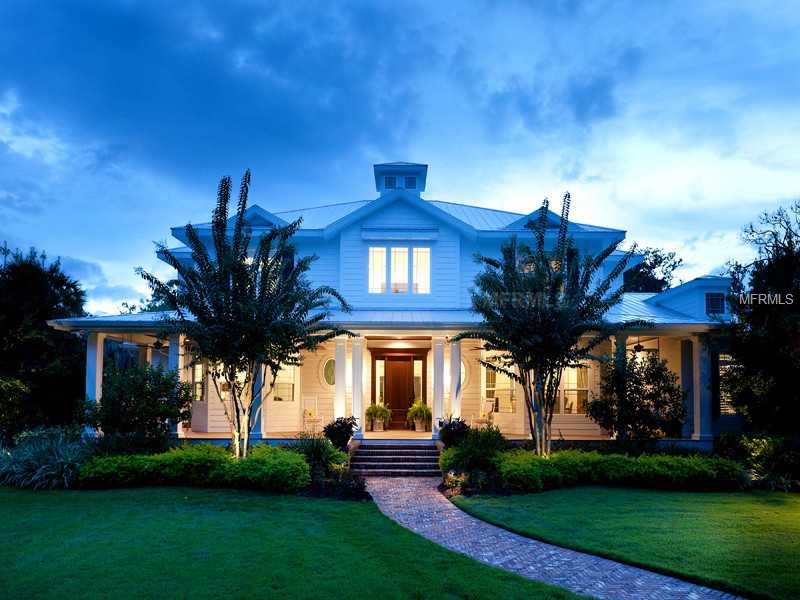 A rare opportunity that brings together acreage, a convenient in-town Sarasota location, a compound like estate and protected boat dockage with easy access to the Intra-Coastal Waterway. This majestic coastal plantation style home idyllically positioned on over 2 acres along the enchanting waters of Phillippi Creek. Exquisitely finished to the finest detail, this sprawling residence features wrapping porches, a vast open pool area, boat dock with lift, a fully equipped guesthouse, two laundry rooms, an expansive game room and a five-car garage. Upon entering this warm southern estate, one is overcome by the attention to detail seen at every turn. The focal point of the home is the magnificent kitchen with custom cabinetry, professional appliances and an enormous functional island. Understated elegance resonates through the use of high-end finishes from the antique Chicago style pavers, to the hammered copper farmhouse sink, mosaic tile, intricate hardware, exotic granites, wood flooring and custom cabinetry. Literally no detail has been overlooked in this custom designed home built by Jonas Yoder. The master retreat is an oasis and each of the four guest suites features a custom built-in desk area as well as lavish en-suite baths. This picturesque setting is highlighted by ancient oak trees and the gentle waters of Phillippi Creek all while being conveniently located in the center of Sarasota.