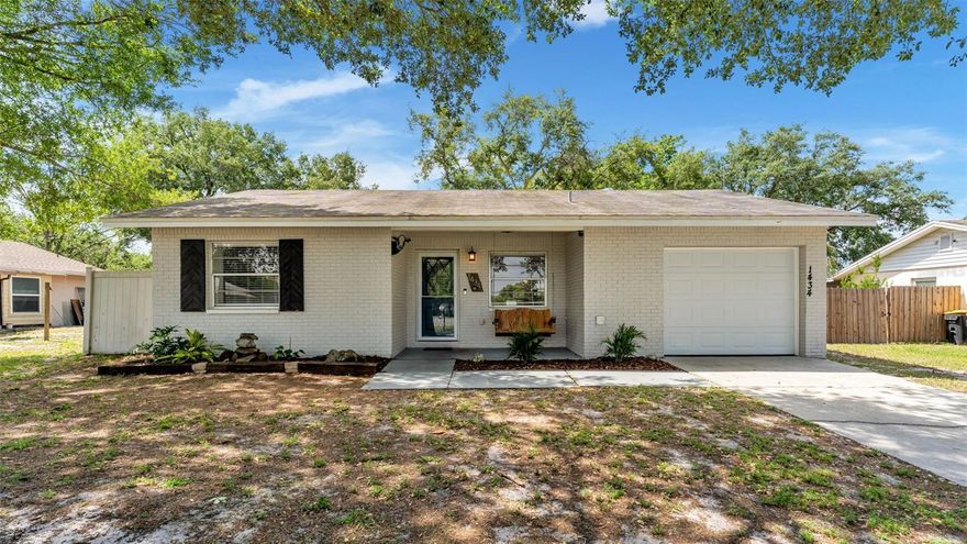 Welcome to 1434 Periwinkle Ct in Lakeland, located in the established community of Wildwood. This beautifully updated 3-bedroom, 2-bath home offers a functional layout with modern finishes and has been well maintained with routine servicing, making it truly move-in ready. Situated just steps from the community park, the location provides everyday convenience and a great outdoor extension of your living space. Inside, you’ll find an upgraded kitchen complemented by wood-look tile flooring throughout the main living areas and comfortable carpet in the bedrooms. A spacious secondary flex space extends beyond the living room, offering the perfect spot for a dining area with room for a full table, all adjacent to the kitchen and overlooking the main living space, ideal for both everyday living and entertaining. A large Florida Room adds even more versatile space, perfect for relaxing or hosting guests, along with an additional flex area suited for a home office or extra storage. The home also features a single-car garage and a large, fully fenced backyard with a convenient double gate, ideal for additional storage, trailers, or easy backyard access. Enjoy a welcoming front porch, perfect for adding a bench and spending time outdoors, along with ample backyard space for entertaining or everyday enjoyment. The home is constructed on a concrete slab with public water and sewer through City of Lakeland Utilities and includes washer, dryer, and kitchen appliances. A new water heater was installed in 2026, and additional features include a private camera security system (recorder needed), Frontier internet availability, and pest control serviced by Florida Pestworx. A brand new roof will be installed prior to closing, giving the buyer the opportunity to choose their preferred shingle color. Wildwood residents enjoy a prime South Lakeland location close to Lakeland Linder International Airport, Publix Corporate, GEICO, and Amazon. You’re just minutes from Publix at County Line Road, Lakeside Village, and an abundance of dining and shopping options, with easy access to the Polk Parkway and Interstate 4 for a seamless commute to Tampa or Orlando. Whether you're a first-time buyer, downsizing, or investing, this home offers the perfect blend of updates, space, and location. Reach out today to schedule your private showing or for more details.