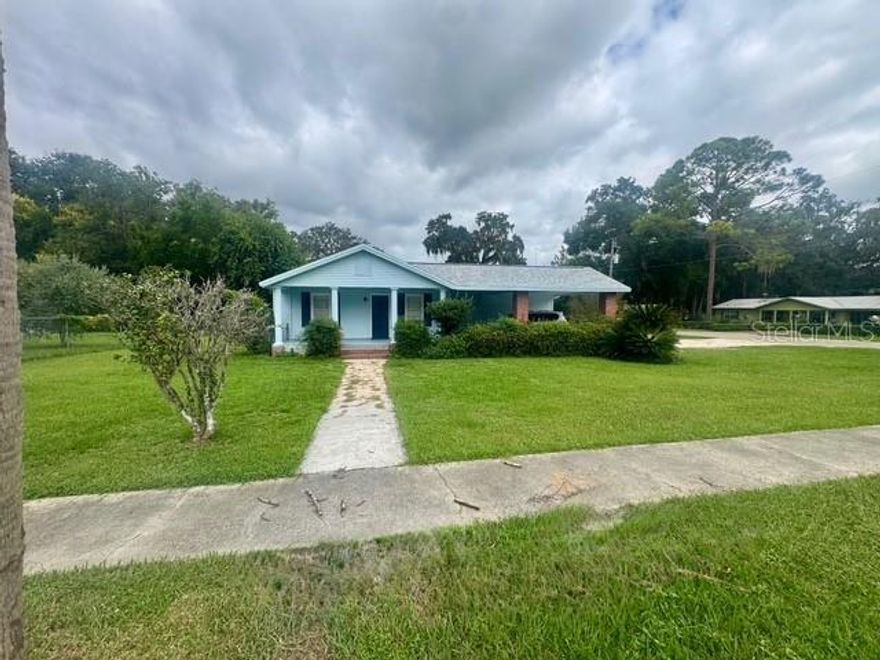 Updated with timeless style, this turnkey Williston home sits on a ¼-acre corner lot with covered parking and a manicured yard in a walkable setting near local shops and dining. Inside, luxury vinyl plank floors pair with new designer lighting, while the big-ticket items are done: NEW ROOF (2024), NEW HVAC (2024), NEW WATER HEATER (2024) and NEW ELECTRICAL (2024). The flexible layout features a huge bonus room that can function as a guest/in-law suite or studio, perfect for multi-use living, a home office, or creative space. Enjoy the convenience of a paved corner location, easy access to area amenities, and the cost advantage of Levy County taxes. A tasteful renovation with practical upgrades—move in and start living. (Buyer to verify measurements, uses, and all improvements.) This home is truly winner, especially considering the additional living quarters with separate entrance (potential income-producing). Affording this home may be easier than you think! New photographs coming soon.