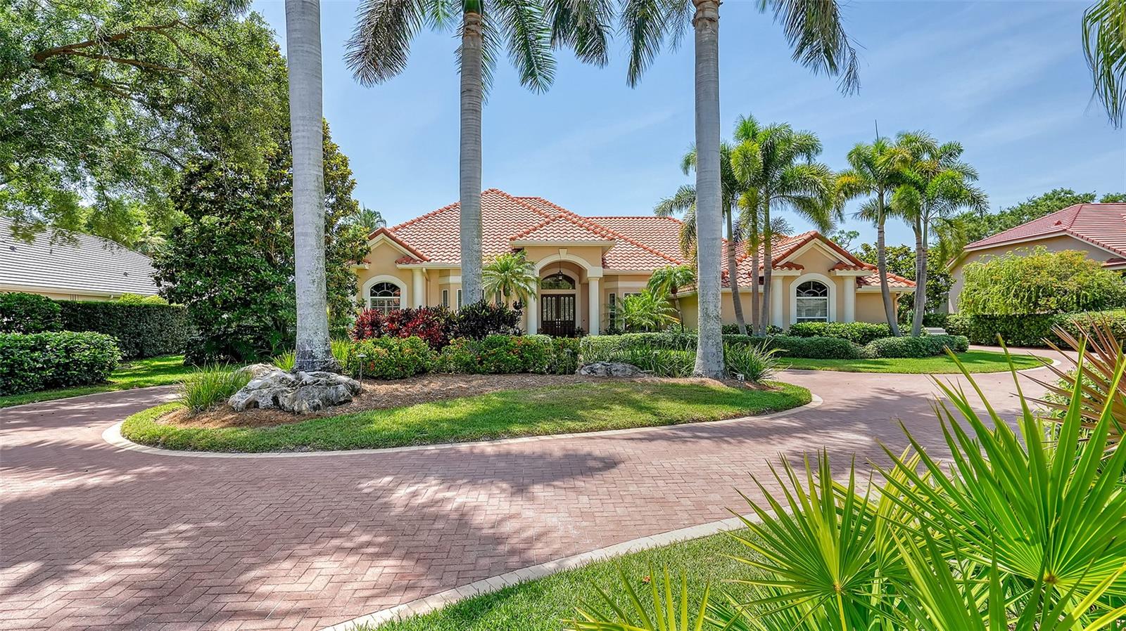 Welcome to your dream home in The Oaks Clubside. Incredible curb appeal will be your first impression of this 4 bedroom (plus office) home with 3 full and one half baths. With a pavered walkway, circular driveway, and lovely landscaping you are beckoned to enter and explore all this Rutenberg built Carlisle model has to offer. Walk through the double doors with leaded glass and you will immediately be impressed by how obviously special this home is. Tastefully updated and impeccably maintained, every detail is designed to delight. The formal living room is a study in elegance. The open kitchen is perfectly designed. It has new appliances, a wide expanse of counter space, beautiful cabinetry, unique ceiling with lighting and a center island cooktop. Opening on one side to the den with fireplace and built-ins, it has a small breakfast bar and a breakfast nook with an amazing view out to the pool area. With a formal dining room, wet bar and butler’s pantry, this home allows you to engage in all manners of entertaining, from causal meals to exquisite formal dinner parties. The master suite is huge, with a sitting area, doors to the lanai and an ultra large and luxurious bathroom. The office with built-ins, guest bedrooms and beautifully updated baths are all spacious; this house truly lives large. Step out back and your delight with this home will be doubled. Extensively renovated, this space is truly made for Florida living. The large, covered areas provide room for dining al fresco, or just sitting and visiting with friends in the shade. There is also plenty of room to bask in the sun on the huge pool deck, and the gorgeous pool and spa beckons you to splash away a tropical afternoon. Situated on the 5th hole of the Heron, the views from here are pretty in the daytime and gorgeous as the sun sets. If you are looking for an immaculate home that is ready for you to move in and begin living an enviable country club lifestyle, you have found it! The Oaks Club, Sarasota’s premiere golf and country club, has two championship golf courses, tennis and pickleball courts, a Junior Olympic community pool, a state-of the-art wellness center, and a wide variety of recreational and social activities. Located in south Sarasota, the community is minutes from nationally ranked Pine View School, and close to the Legacy Bike Trail, world renowned area beaches and all the shopping, dining and cultural offerings of downtown Sarasota.
