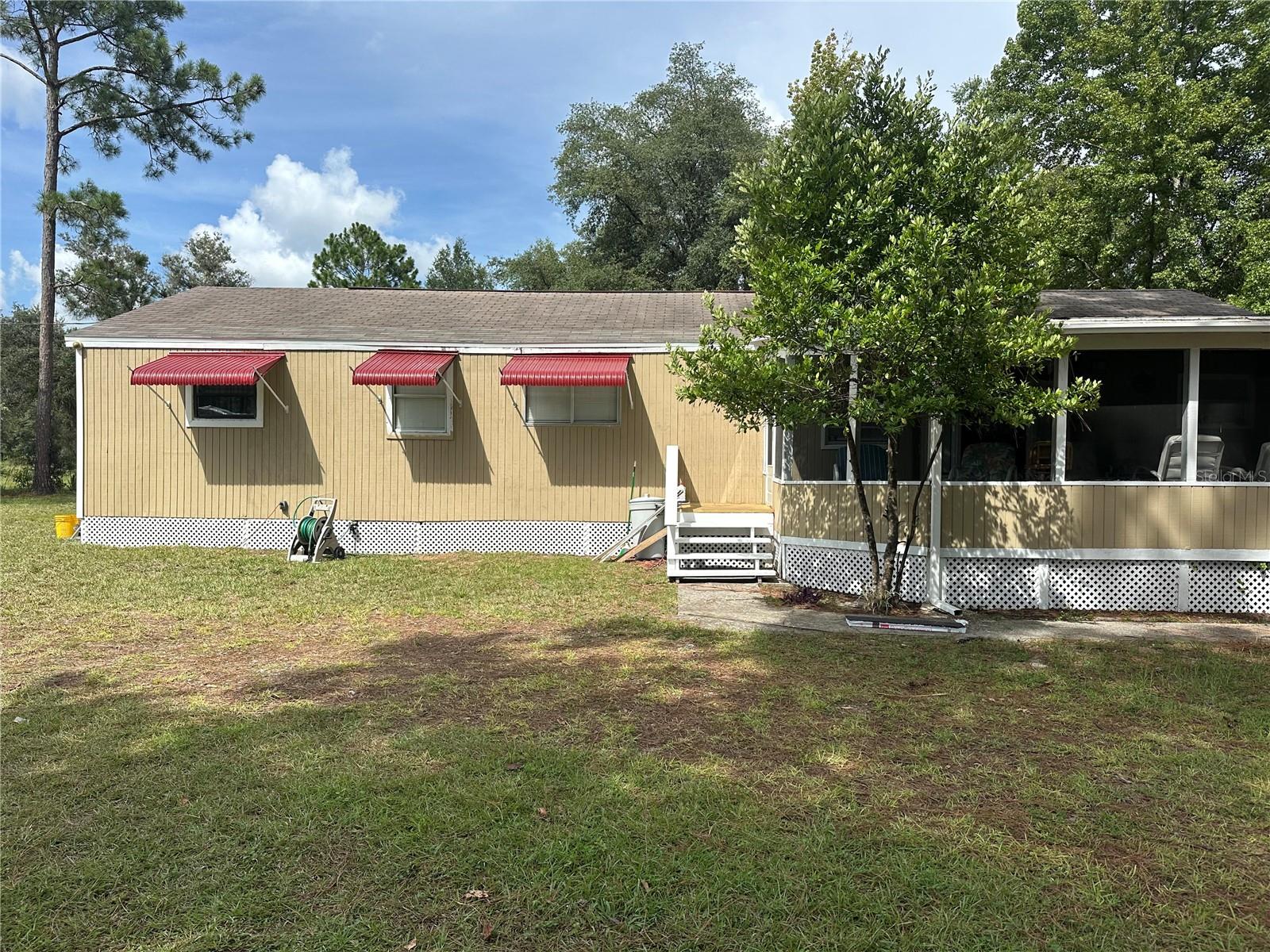 Bring the CHICKENS! Charming 4-Bedroom, 2.5-Bath Home on Nearly 1 Acre in a Peaceful Country Setting. Tucked away on a quiet street, this well-maintained home offers the perfect blend of rural charm and modern convenience. Close to shopping, there’s room for everyone—plus a little extra!
The best part is the outdoors with just under an acre of land, ideal for gardening, pets and chickens. A gate, a partial fence that can be connected to the back. A side deck for functionality. Large screened porch in the front. The property features a newer septic system, a newer A/C unit, a new well pump, and an 8x12 side deck just off the laundry room—perfect for morning coffee or evening relaxation.
Oversized detached 3-car carport approx 7.5 ft tall and additional sheds (2) for storage. A quiet place to call home or a mini homestead, this move-in-ready.
Country paradise—schedule your showing today!