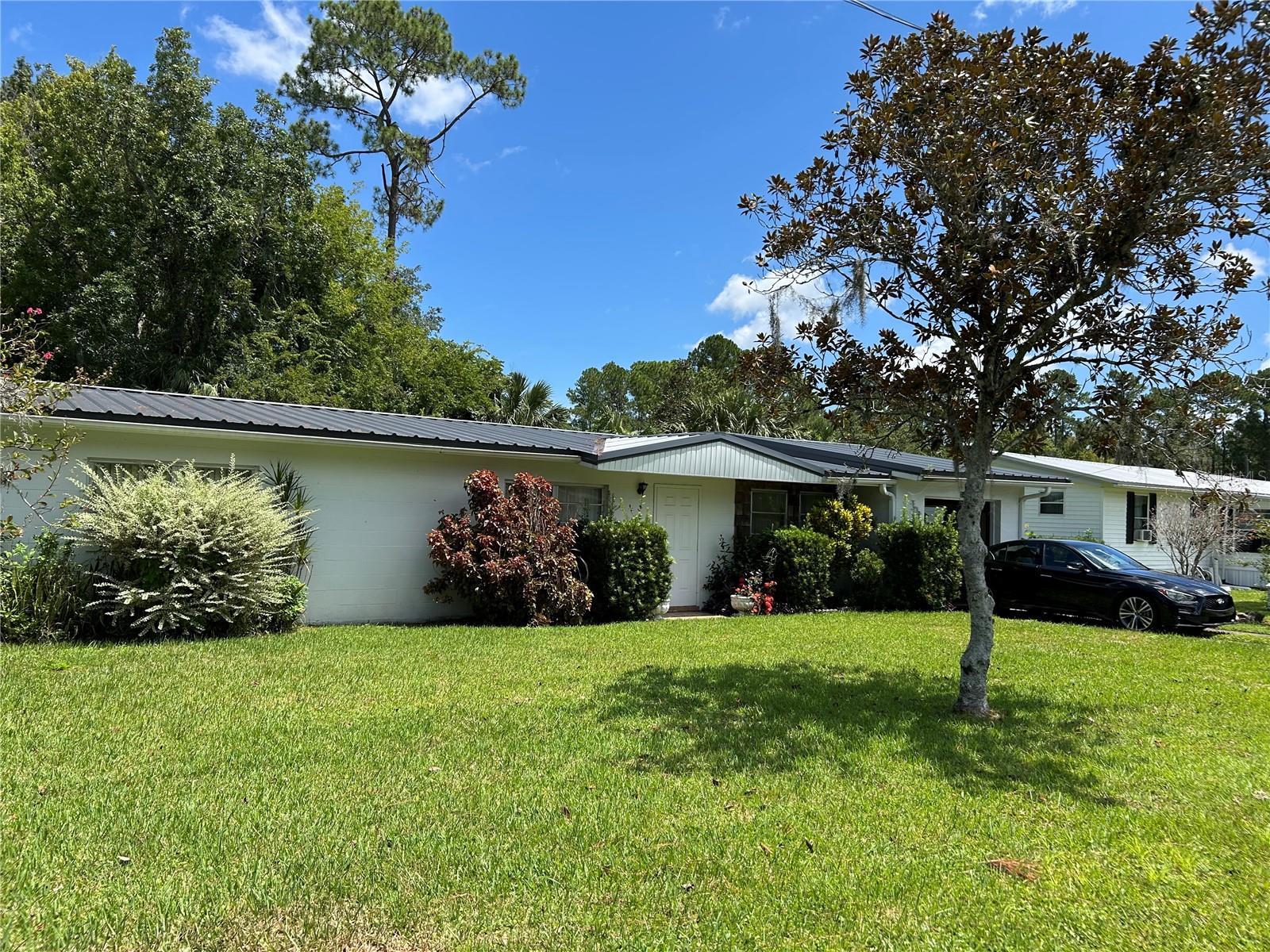 This comfortable, well maintained, 2 bedroom, 1 1/2 bath, concrete block home has two large outbuildings, for all your workshop and storage needs. Sturdy home with newer metal roof installed in 2021, new A/C and heat pump installed in 2020, new breaker box installed in2022 and new conduit and wire to the large garage installed in 2023. Located on two lots gives you plenty of room between you and your neighbors. The town of Astor has that small town feel with multiple restaurants, grocery store, and fresh seafood shop. With the St. Johns River Running Thru it, fishing is a main attraction as well as the springs located just a short boat ride away. Just relaxing, cruising down the river can be a wonderful time. Astor is surrounded by the Ocala National Forest with an abundance of wildlife, hunting and side by side riding are a great hobby here. As well as being centrally located, Ormond Beach is 40 minutes away, Orlando 1 hour, Ocala 40 minutes and the great little town of Deland is 30 minutes away. Put this one on your list to see, make a showing appointment today!
