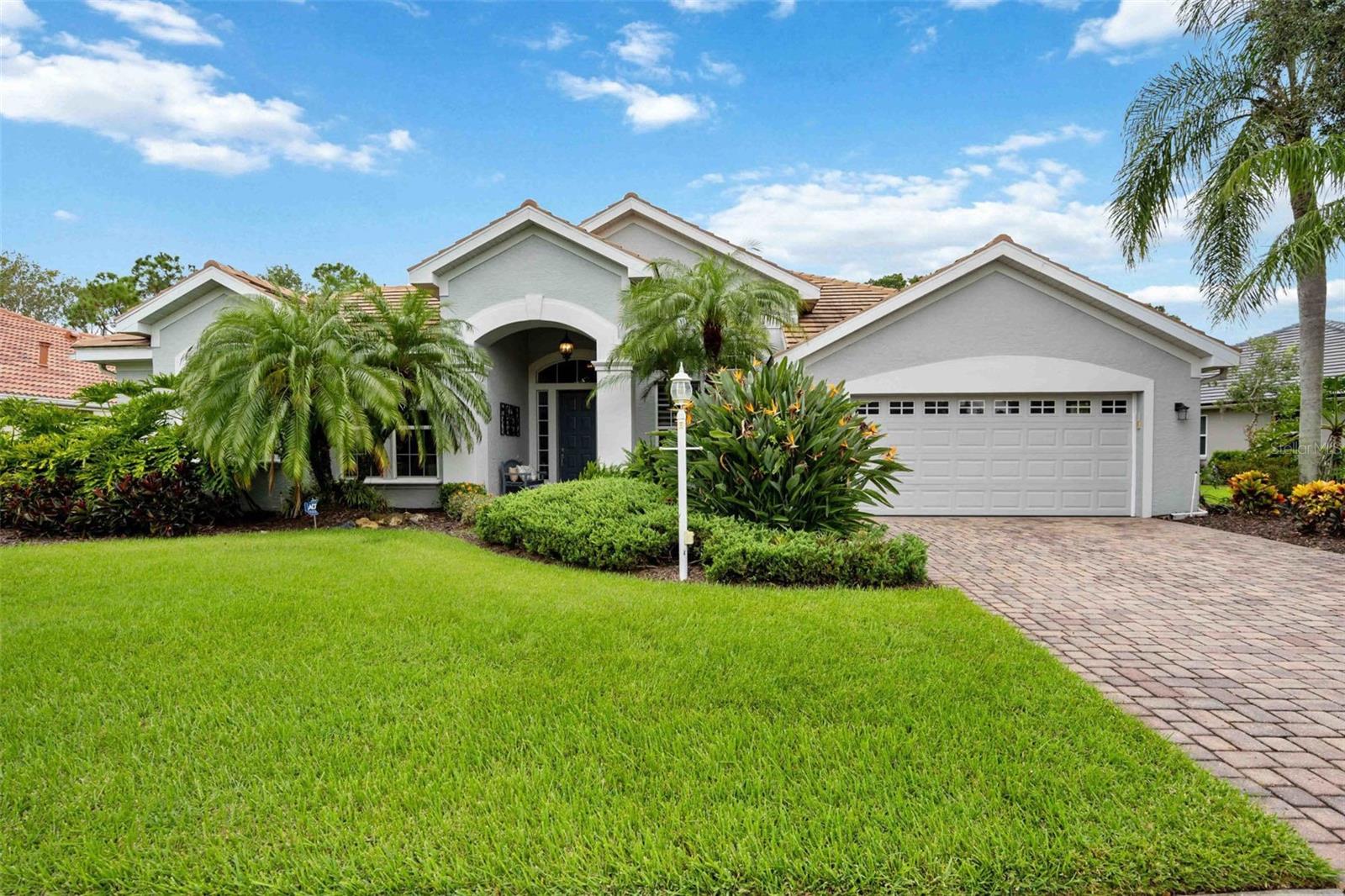 One or more photo(s) has been virtually staged. Fabulous award-winning custom floor plan by Anchor Builders in the desirable Edgewater community. This 3 bedroom, 3 bath residence with additional den and oversized 2-car garage features timeless design and quality craftsmanship throughout. The home offers an expansive heated pool and screened lanai with generous deck space, surrounded by lush landscaping for plenty of back yard privacy. It's a beautiful and private wooded preserve view! There are no houses in rear yard, plus lots of side yard privacy landscaping. A serene park is located directly across the street. Highlights include 18" diagonal tile flooring, tray ceilings, extensive crown molding, a large kitchen with island. The primary suite features a spa-inspired bath with jetted tub, dual vanities, and walk-in shower. Energy-conscious features include a radiant barrier, in-wall pest control. Since purchase, the owners have made extensive improvements. These include: a ROOF REPLACED in (2017), KOHLER WHOLE-HOUSE GENERATOR (2023), new A/C in (2023), pool heater and water heater replaced during ownership. The pool bath and guest bath were fully renovated with new cabinetry, fixtures, glass block windows, tile walls and flooring. Kitchen enhancements include granite countertops, backsplash, sink, faucet, CULLIGAN WATER PURIFICATION SYSTEM, and UPDATED APPLIANCES (GE washer, dryer, microwave, Miele dishwasher). The lanai was updated with travertine pavers and new screens, and landscaping upgrades include a tall hedge row for privacy. Additional features: Hunter Douglas window treatments, interior and exterior paint, custom closet shelving, new fans and chandeliers, added ceiling lighting, grab bars in all baths, and garage storage shelving. A natural gas community too! Located in the heart of Lakewood Ranch near University Parkway, this residence offers easy access to Main Street, Waterside Place, UTC Mall, the Polo Club, medical facilities, top dining, and Sarasota’s cultural amenities. Residents also enjoy access to Lake Uihlein with convenient kayak storage. This is a meticulously maintained home in one of the area’s most desirable neighborhoods—your HOME IN PARADISE awaits!