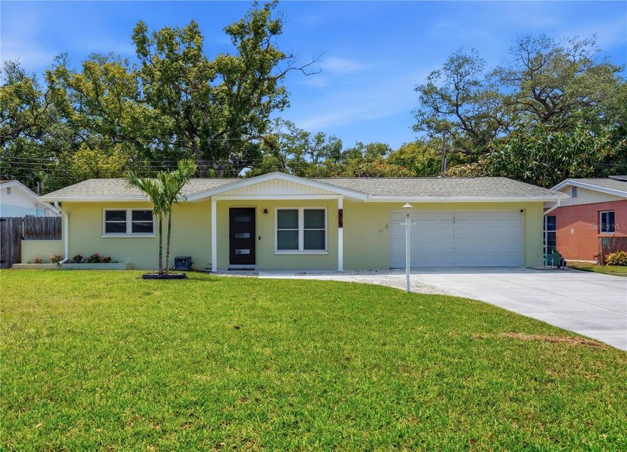 One or more photo(s) has been virtually staged. Set on a charming street in Seminole, this beautiful home offers an exceptional location near top-rated schools, stunning Gulf beaches, and close to shopping, dining, and local favorites. From the covered entry, step inside this gorgeous split floor plan, block construction home to an open and bright living room with a built-in tree hall and thoughtful updates. Wood-look flooring traverses into the kitchen where you will appreciate the curated feel with handmade tiling, novelty lighting, stainless steel appliances and dazzling stone counters. There is an abundance of cabinetry space including a built-in pantry with pull out drawers. A custom wet bar with glass shelving awaits your favorite coffees and teas and includes a mini sink with a water filtration system. The kitchen opens naturally into a dedicated dining space that invites your guests to gather and stay awhile. Additional built-in cabinetry in the dining room provides room for linens and serving ware. Beyond the dining room, the enclosed Florida room offers flexibility—a quiet office, lounge, or creative space—complete with custom cabinetry . The primary suite is set apart for privacy, with glass sliders to the back yard where you can add a hot tub or deck with private seating. The en-suite bath is classic and bold, finished with a dual vanity, striking midnight glass tile, and an elevated, timeless feel. The oversized additional closet and secondary access further enhance the suite’s practicality. On the opposite side of the home, the spacious second and third bedrooms sit alongside an updated hall bath, creating a comfortable and functional layout for family or guests. The backyard is a blank canvas with just the right balance—room to design a dreamy outdoor living and dining space, without the upkeep that takes away from weekends better spent at the beach. The fully fenced yard provides privacy and space to unwind, while the oversized two-car garage offers plenty of parking plus bonus storage. Intentional storage has been incorporated throughout, adding a level of function that supports everyday living and seamless design. New AC (2024) and Water Heater (2024), Hurricane Rated Windows, Irrigation on Reclaimed Water, Laundry with Storage in the Garage, a Storage Shed in the Back Yard, and a large, oversized driveway are some of great features of this home. The location is equally compelling. Positioned over 50 feet above sea level on Seminole's natural limestone ridge, and within a highly sought-after school zone, this home pairs everyday convenience with long-term value. The serene waves at Indian Shores Beach are an easy bike ride down Park Blvd, and larger beaches are a short drive. The Pinellas Trail and Seminole City Park are steps away, offering a scenic pond, playgrounds, outdoor amphitheater, and regular community events. There are several other parks for family recreation nearby, including Boca Ciega Millennium with boardwalks overlooking the intracoastal, Lake Seminole and Walsingham Parks with scenic walking paths, and Waterfront Park on the bayou with a dock and playgrounds. As a Seminole resident, you’ll also enjoy perks at the Seminole Recreation Center, with a pool, fitness classes, gym, courts, camps, and more—an extension of the lifestyle this location naturally supports. Seminole City Center is half a mile away and features an array of shops, restaurants, and a luxury movie theater. This is a home where the setting delivers just as much as the space itself.