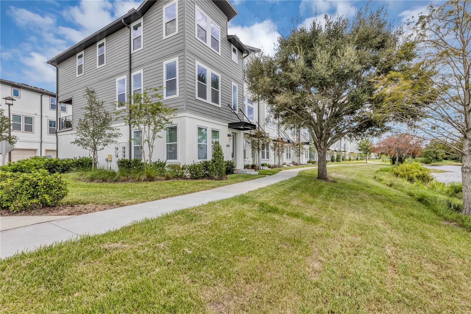 Discover the charm of this elegant 3-bedroom townhome nestled in Laureate Park at Lake Nona community. Spanning three stories, this townhome offers picturesque water views and a blend of modern comforts. On the ground floor, find a spacious bedroom, a full bath, and a convenient 2-car garage. The second floor boasts a well-designed great room layout, with the living room seamlessly connected to the modern kitchen. From here, step out onto a private balcony that overlooks the serene surroundings. The kitchen showcases 42' cabinets, sleek quartz countertops, and a suite of stainless steel appliances. Throughout the living areas, enjoy the timeless appeal of Luxury Vinyl Plank flooring. Ascending to the third level, you'll discover a lavish master suite accompanied by an indulgent master bath. An additional bedroom and bath provide ample space for guests or family members. Indulge in the community's luxurious amenities, including access to the state-of-the-art Aquatic Center featuring two inviting swimming pools and a sand volleyball court. This prime location also places you within the sought-after A-rated school district, ensuring excellent education opportunities for your family. Convenience is at your doorstep with easy access to everything: shopping, dining, outdoor activities, major highways to take you to the beautiful coast and beaches! Schedule a viewing today!