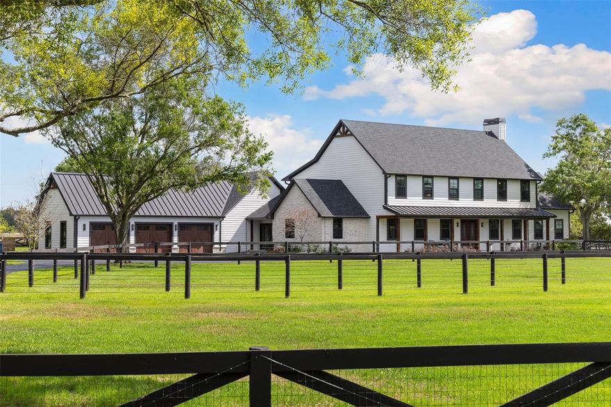 Welcome to 11602 Innfields Drive — a rare and remarkable equestrian estate centrally located in Odessa. Privately gated and situated on 5.95 acres, this multi-residence compound has been completely transformed with over $1,500,000 in thoughtful upgrades, offering a true turnkey lifestyle for horse enthusiasts. From the moment you arrive, the level of care and detail is undeniable. A new stone-columned gated entry leads to a freshly paved driveway and a newly constructed 3-car garage with a matching metal roof. The expansive main residence spans 6,054 sq. ft. and features 4 spacious bedrooms, 3 full bathrooms, 2 half bathrooms, two private offices, a club-style entertainment room, formal living and dining area, a dedicated laundry room off the primary suite, laundry on first floor, and a reimagined outdoor living space with a covered patio and new outdoor kitchen overlooking the heated saltwater pool and pasture. There’s even a cozy fire pit just beyond the lanai, perfectly positioned to overlook the private riding arena—an ideal spot to unwind after a day of riding. Additional living spaces include an updated 525 sq. ft. guest cottage with 1 bedroom and 1 full bathroom, plus a private 411 sq. ft. apartment above the barn equipped with a bedroom, full bathroom, and kitchen—ideal for extended family, guests, or a live-in trainer. A newly built 2,600 sq. ft. workshop with an 633 sq. ft. air-conditioned mezzanine offers incredible flexibility for a gym, office, game room, or additional guest quarters. The workshop also includes designated storage for hay, feed, and equipment, along with a wet room and oversized 14 ft. garage door—perfect for RVs, boats, or trailers. The equestrian amenities are truly world-class. The 8-stall horse barn is equipped with individual stall fans, a dedicated tack room with its own mini-split A/C and washer/dryer, and a separate lounge room with A/C, half bath, and vanity—perfect for relaxing between rides. The professionally built 90x160 riding arena features full irrigation and six stadium lights, allowing for comfortable day or night training. Its footing matches that of the World Equestrian Center, offering premier rideability and performance. The property also includes eight paddocks; six of the paddocks have their own automatic watering system for maximum convenience and equine care. Major infrastructure upgrades include a newer roof (2021), newly added in-law suite of the 3 car garage addition, spray foam attic insulation, a redesigned well and water treatment system, a modern septic system, irrigation covering over four acres, new gutters, a propane tank (for pool heater & outdoor grill), and extensive professional landscaping. Additional features include a turf dog run, a chicken coop, and a full-service RV pad with hookups—completing this one-of-a-kind, move-in-ready equestrian estate. Enjoy the peace and privacy of country living while being just 20 minutes from Tampa International Airport and close to Publix, Starbucks, dining, and top-rated schools. With no HOA and a location less than two hours from the World Equestrian Center in Ocala, this is a rare opportunity to own a move-in-ready, multi-residence equestrian estate offering the perfect blend of luxury, land, and lifestyle. Offered at $2,995,000 — well below estimated replacement cost.