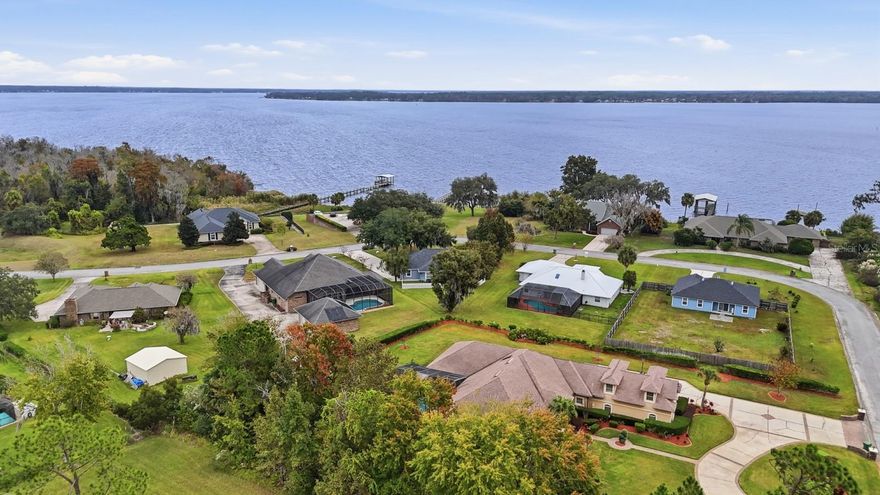 Beautifully located & designed, this 3 bed, 3 bath home with a bonus office and formal dining room offers peaceful riverfront living. No HOA/CDD and just steps from the public marina- perfect for year round water access. Inside, the home features a 2 car garage, split floorplan, renovated kitchen with stainless steel appliances, new countertops, backsplash, and a double oven, along with updated flooring, fresh paint, tall ceilings, and large windows that fill the home with so much natural light. Each bedroom is conveniently located near a full bath, and the primary suite includes a garden tub, separate shower, separate vanities and huge custom closet. Additional interior upgrades include a renovated breakfast nook, custom tile, a 'stained-glass' looking entry feature, and a beautiful glass front door. Outside, enjoy serene water views with stunning sunsets from your pergola with paver patio, or hang out in the back yard complete with white picket fencing and mature, well kept landscaping throughout the property. A 4-year-old architectural roof, a newer HVAC system with transferable warranty, and 2018 water heater add peace of mind on those big ticket items.