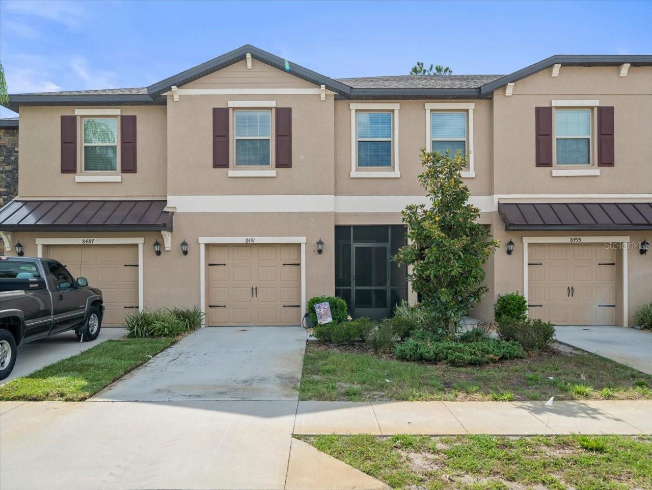 Welcome to 8491 Essington Street – a beautifully crafted, newly built townhome in the gated Ventana at Waters Edge community! This move-in-ready gem, built in 2021, features 1,666 sq ft of elegant living space, including three bedrooms, two full bathrooms, and a convenient loft, as well as upstairs laundry facilities. Highlights include: Large family room with 18" tile flooring, modern ceiling fan, and plenty of natural light. Chef’s kitchen boasting stainless steel appliances, 42" staggered cabinets, granite countertops with breakfast bar, brushed nickel fixtures, and pendulum lighting. The dining area opens via sliding glass doors to a screened lanai overlooking a serene conservation area, as well as a pavered deck ideal for grilling. Primary suite with walk-in closet, tranquil conservation views, and en-suite bath featuring dual sinks and a walk-in shower. The guest bedrooms are spacious, carpeted, and feature double closets. The front screened veranda offers a welcoming entry. Additional perks: water softener, attached garage with opener. Community Perks: Enjoy resort-style amenities with two swimming pools, fitness center, clubhouse, basketball courts, playgrounds, and more—all within the gated neighborhood