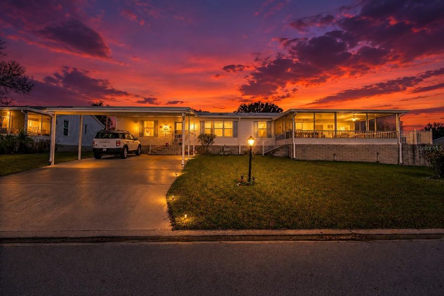Enjoy easy Florida living in this spacious and beautifully maintained 3-bedroom, 2-bath home offering 1,818 square feet in a highly sought-after 55+ community. Thoughtfully designed with a split-bedroom layout for added privacy, this move-in-ready residence also features a flexible bonus room ideal for an office, hobby space, or additional sitting area. The oversized screened porch creates the perfect setting for morning coffee, evening relaxation, or entertaining guests year-round. A double carport provides ample covered parking, while the large storage room offers plenty of extra space for tools, seasonal items, or golf cart storage. Residents enjoy an active resort-style lifestyle with outstanding amenities including an 18-hole golf course, clubhouse, community pool, tennis courts, dog park, on-site restaurant, and more—all just a short walk or golf cart ride away. The affordable HOA fee includes lawn care, cable, internet, and a guarded gated entrance for added convenience and peace of mind. Surrounded by scenic lakes and outdoor recreation, this location is perfect for boating, fishing, and enjoying the Florida sunshine. Conveniently located less than 45 minutes from Orlando International Airport and Orlando’s famous attractions, this central location also offers easy access to both the Atlantic and Gulf Coast beaches. Whether you’re searching for a full-time residence or seasonal retreat, this home offers comfort, convenience, and an unbeatable lifestyle.