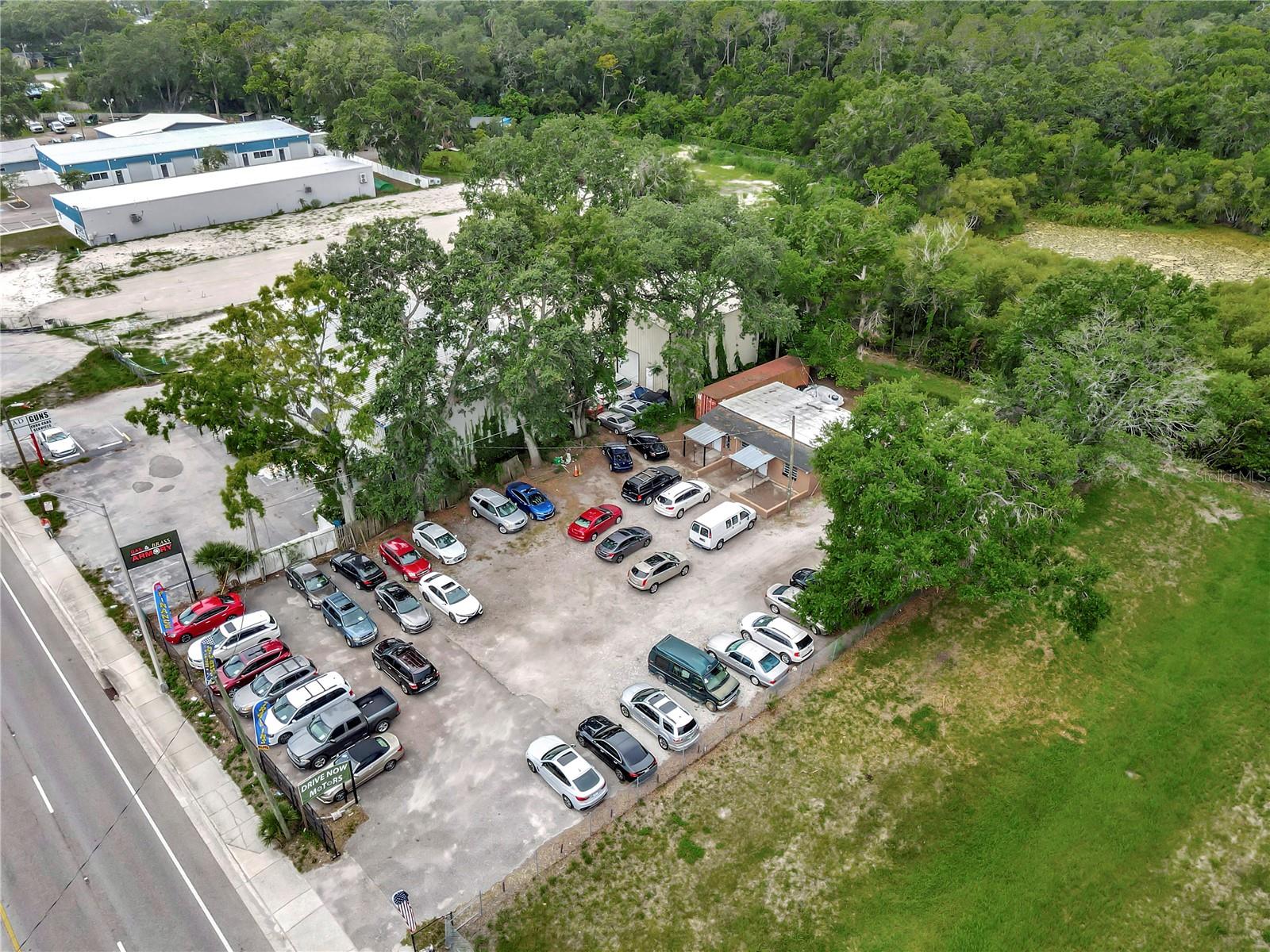 Rare CG-zoned 0.43-acre parcel at 14230 N Florida Ave—one of the last commercial lots of its size on this high-traffic corridor—currently operates as a turnkey auto dealership and conveys TWO active Florida DMV dealer licenses, enabling dual-tenant income streams or a thriving owner-user business. The 1,140 SF concrete-block office boasts a brand-new A/C system, multiple private workspaces, dedicated storage, and customer reception. A covered pavilion to the right of the building is ideal for mechanic services or detail bays while expansive asphalt frontage offers abundant display parking and easy entry and exit on North Florida Ave/US-41. Flexible Commercial General zoning supports a wide array of uses—showroom, contractor yard, equipment rental, retail, or redevelopment—with immediate access to I-275, Fletcher Ave, and Downtown Tampa. Position your business—or your tenants—on a signalized, visibly prominent site averaging 29K AADT and capitalize on hard-to-find automotive infrastructure in a supply-constrained market.