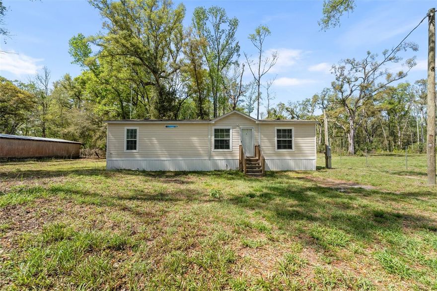 Welcome to 3455 NE Highway 349 — a beautifully maintained 2023-built mobile home offering the perfect blend of modern comfort and peaceful country living. Situated on a spacious 1-acre lot, this 3-bedroom, 2-bathroom home is ideal for those seeking both convenience and room to spread out.

Step inside to discover a bright, open-concept layout featuring a stylish kitchen with ample cabinet space, a center island for entertaining, and seamless flow into the dining and living areas. Natural light fills the home, highlighting the clean finishes and inviting atmosphere throughout.

The primary suite offers a relaxing retreat with a spacious bathroom, complete with dual vanities and a large garden tub — perfect for unwinding after a long day. Two additional bedrooms provide flexibility for family, guests, or a home office.

Outside, enjoy the privacy and possibilities of your full acre — perfect for outdoor activities, gardening, or simply relaxing in a serene setting. A standout feature of this property is the large workshop, offering incredible space for storage, hobbies, or business use.

Conveniently located with easy access to nearby amenities while still maintaining a quiet, rural feel, this property is a rare find.

Don’t miss your chance to own this move-in ready home with room to live, work, and play! Schedule your showing today!