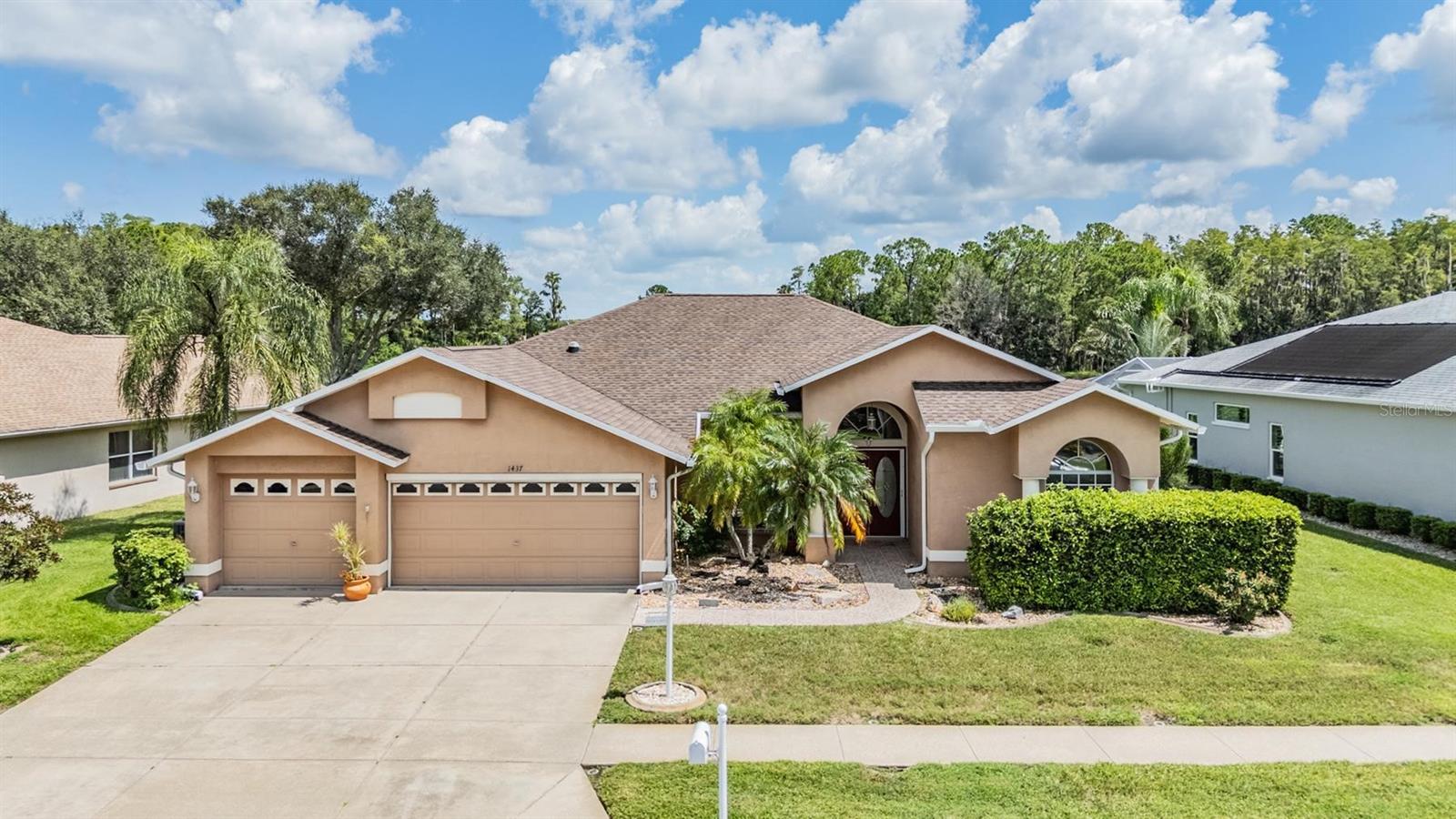 Gorgeous Pond & Pool Views from Your Private Oasis! ROOF REPLACED 2020; NEW A/C 2025. FIBERGLASS POOL REDONE LESS THAN 5 YEARS; SOLAR POOL HEATER; ELECTRIC SCREEN GARAGE DOOR; HOT WATER HEATER REPLACED 2010. Step inside and be welcomed. A sought-after 3-car garage provides ample storage and space for your vehicles, with the option to purchase the NEWER lithium golf cart as well (ask agent for details). The home welcomes you with a bright dining area just off the foyer, highlighted by a large arched window that sets the tone for this elegant home. The expansive living room draws your eye outdoors with an oversized sliding glass door that opens to the covered lanai and sparkling screened-in pool overlooking a serene pond—your perfect daily retreat. An arched doorway leads to the spacious kitchen, designed for both style and function. Featuring pendant lighting, stone countertops, a breakfast bar, stone backsplash, recessed lighting, and abundant counter and cabinet space, this kitchen flows seamlessly into a cozy breakfast nook and an additional living area. With yet another oversized sliding glass door, you’ll enjoy uninterrupted views of the pool and pond, blending indoor comfort with outdoor beauty. The primary suite is a true retreat with soaring ceilings, private lanai access, dual walk-in closets with shelving, and a generous en-suite bath boasting a soaking tub, step-in shower, and a large privacy window that fills the space with natural light. Secondary bedrooms are equally inviting, including one with a custom Murphy bed for flexible use. Practical touches continue with a walk-in laundry room complete with built-in cabinets, ventilated shelving, and tile flooring. Outdoors, the oversized covered lanai offers plenty of room for lounging or entertaining beside the sparkling pool—an unbeatable spot to start or end your day. 55 & FUN - LIVE THE HERITAGE SPRINGS LIFESTYLE - Resort style living at its absolute finest! Clubhouse with restaurant and bar, fitness, tennis, golf, cards, billiards, dancing and more! SUPERB TRINITY LOCATION, CLOSE TO BEACHES, DINING, SHOPPING, MEDICAL AND AIRPORT! Caution - Adults at Play!