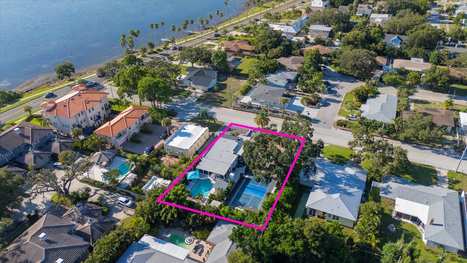 No words needed for this one-of-a-kind Florida bungalow just a short golf cart ride from Downtown Dunedin. Enjoy a private, fenced pickleball court, sparkling pool, and breathtaking views of St. Joseph Sound, all in a non-flood zone. Fully updated with a new roof, AC, impact windows and doors, plumbing, electrical, modern kitchen, bathrooms, appliances, and energy-efficient insulation. Detached workout room and air-conditioned detached man cave/she-shed complete this historic gem. Schedule your tour today—Paddles Up!