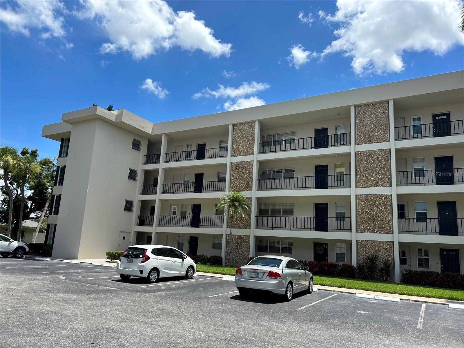 Great quite complex in Palm Aire with sweeping views of water and golf course for miles. This 2nd floor unit has split bedroom plan with both bedrooms having their own bathrooms attached. The back bedroom views over the water and golf course with nice walk in shower. The front bedroom is very nice size with two closet areas, one is a walking closet for lots of storage. Kitchen is updated with stainless steal appliances, newer cabinets with an open pass through that views into dinning/living area and screened balcony with soothing water view. New vinyl flooring in living/dinning areas, new carpet in both bedrooms and freshly painted. This complex has shared washer and dryer facilities, individual storage stall, 2 heated community pools and fitness room.