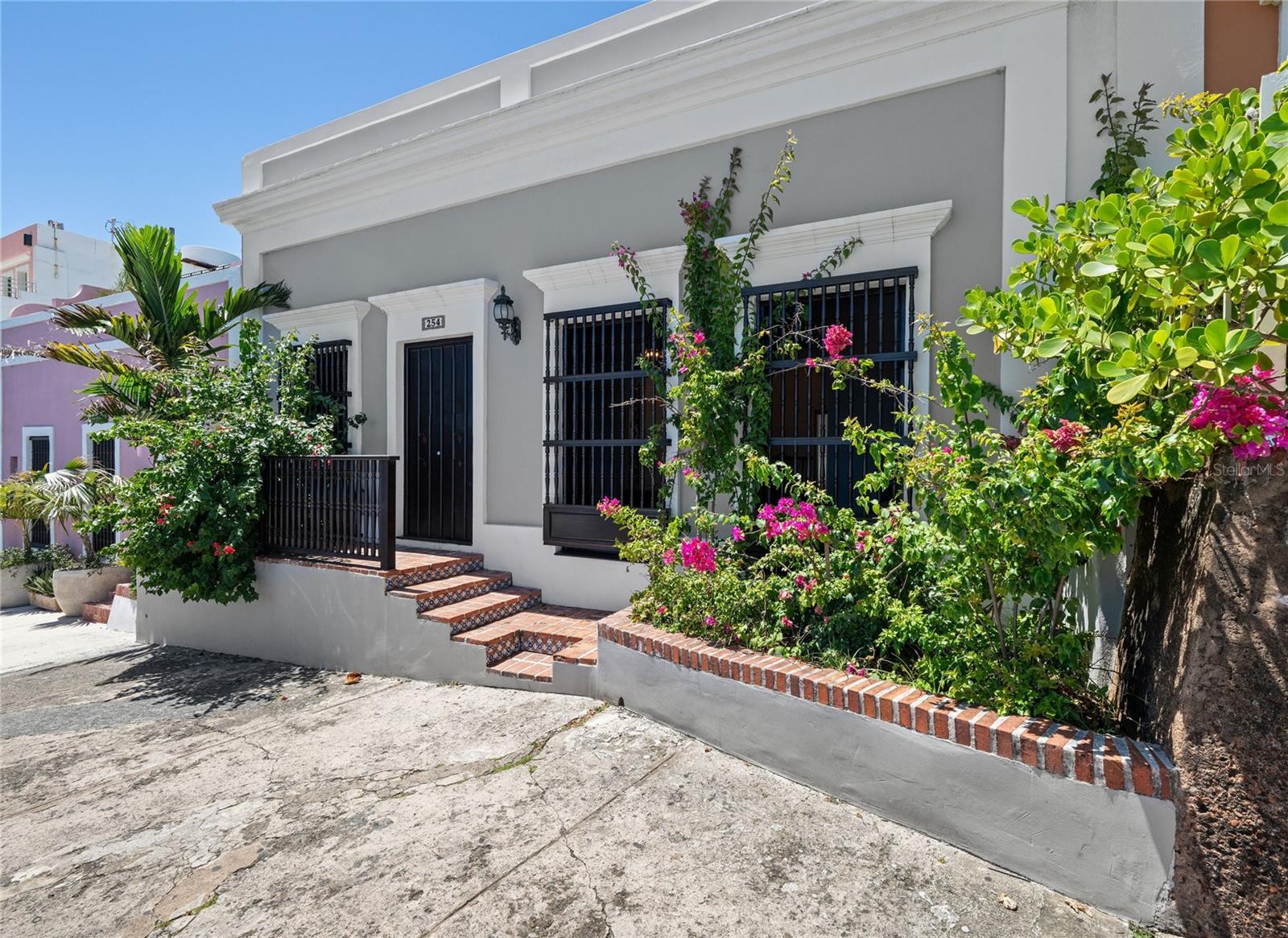Set along the iconic Norzagaray Street in Old San Juan, 254 Norzagaray captures the essence of Spanish colonial elegance and timeless Caribbean charm. With its graceful archways, soaring ceilings, and authentic architectural details, this residence reflects the character of the city’s storied past while embracing modern comfort. Perfectly situated just steps from El Morro and San Juan’s lively plazas, the home offers an unmatched lifestyle in one of the Caribbean’s most enchanting historic districts.
Inside, the property offers expansive living areas bathed in natural light, showcasing restored woodwork, original tile flooring, and spacious layouts perfect for both relaxation and entertaining. The kitchen and dining areas flow seamlessly, while multiple bedrooms provide comfort and privacy. Large windows and balconies frame breathtaking views of San Juan Bay and the colorful streets below, creating a unique backdrop that changes from sunrise to sunset.
Outdoors, the residence reveals serene courtyards, rooftop terraces, and open-air spaces ideal for enjoying Puerto Rico’s year-round tropical climate. Whether you’re looking for a primary residence, a vacation retreat, or an investment in the vibrant short-term rental market, 254 Norzagaray offers unmatched character and location. This property is more than a home—it’s a piece of living history in one of the most enchanting settings in the Caribbean.