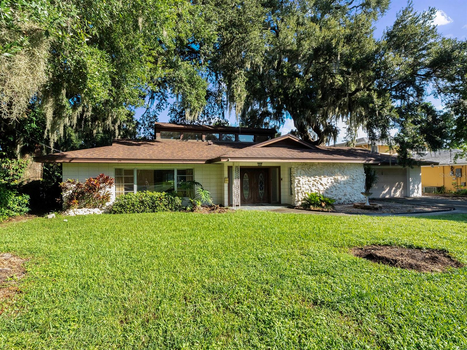 Discover a rare opportunity to own a true lakefront gem in the highly sought-after Conway area, just minutes from the vibrant SODO District. This spacious 4-bedroom, 3-bathroom home offers over 2,500 square feet of living space and sits on an impressive half-acre lot with sweeping views of the lake.
Built in 1964 and cherished by its original owner for more than 60 years, this residence is filled with character and timeless charm. While the home has not been updated, it provides the perfect canvas for those who wish to create their dream lakefront retreat. Generously sized living areas, a functional floorplan, and plenty of natural light showcase the potential this property holds.
Outside, the large lot provides room to enjoy the tranquility of lakefront living, with ample space for outdoor entertaining, gardening, or even adding a pool. The peaceful setting is perfectly balanced by its convenient location close to downtown Orlando, shopping, dining, and top schools.
This is more than just a house—it’s a chance to own a piece of Orlando history and create a lakefront lifestyle tailored to you.