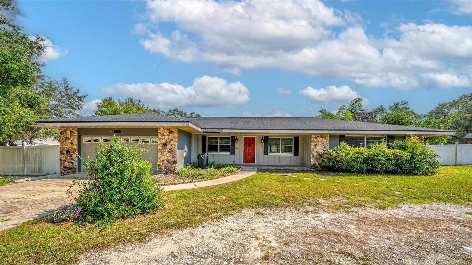 Welcome to this incredibly spacious 3-bedroom, 2-bath home, just 2 minutes from downtown Groveland and 10 minutes from downtown Clermont—two charming lakeside towns filled with many dining and shopping options, recreational bike trails, boat ramps, parks, and year-round local events. Inside, you’ll find beautiful solid wood flooring throughout the home and main living areas, with tile in the kitchen and bathrooms for easy care. A cozy wood-burning fireplace covered in stone adds character to the living/family room area. The owner's suite has excellent natural lighting with 3 big windows facing the backyard, the private bathroom has dual closets, a linen closet, dual sinks, and a shower tub combo. The home offers a designated dining room, and a spacious kitchen with an eat-in space at the bar, two pantries, solid wood cabinets, Formica countertops, a built- in range with a glass cook top and a dishwasher. Just off the kitchen separated by a built-in pocket door are the remaining bedrooms, generously sized with excellent closet space and natural lighting as well. Off the hall is an indoor laundry room with overhead cabinetry and a door that leads to the backyard. There is also a large bonus room off the kitchen through the sliding glass doors -perfect for a playroom, home office, or game room. This home sits on almost a half-acre lot and has a fully fenced backyard featuring a pergola, playground, and plenty of room for entertaining or relaxing. With excellent bones, solid block construction and a little TLC, this home offers a fantastic opportunity to add value and create your ideal living space! Call to book your private showing today!