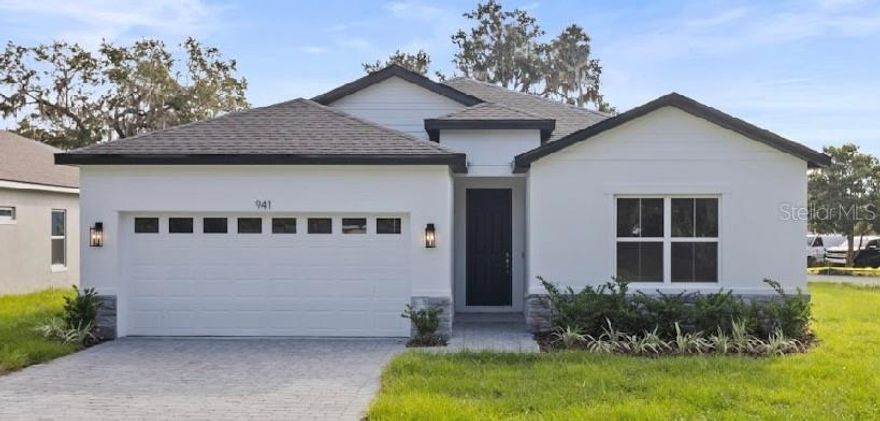 This brand new home in the Arbors of Lake Harris Neighborhood combines modern living with the beauty of nature. Located down the street from a private neightborhood dock on Lake Harris. Enjoy the luxury of launching your boat and taking your friends and family to lunch at one of the many restaurants available on the Chain of Lakes. This 4 bed 3 bath home is fully upgraded with 42' cabinets, Stainless Steel appliances, quartz countertops throughout the kitchen and baths, as well as exquisite Mosaics in the backsplash and Custom Bathrooms. While the split bedroom plan offers privacy, its open concept also gives plenty of room for entertaining guests. Enjoy nature walks, fishing, or the stunning sunrises and sunsets at the Community dock on Lake Harris.