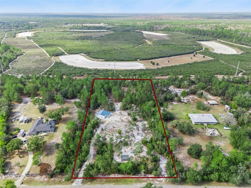 Discover 4.75 acres of A-1 zoned, high and dry vacant land tucked away in the highly desirable Seminole Estates—an equestrian community known for luxury custom homes on expansive parcels. Enjoy the perfect balance of country living with city convenience, all just minutes from A-Rated Seminole County Schools, major roadways, shopping, dining, and vibrant downtown Sanford. This cleared and build-ready property is fully fenced, privately gated, and backs up to the Black Bear Wilderness Preserve, offering exceptional privacy with no rear neighbors and stunning sunset views. Horses and livestock are welcome, and the A-1 zoning allows for agricultural uses, a private farmstead, ADUs, and more—bringing endless possibilities to life. The property features a deep well with brand-new 2025 technology and a 1,290 sq ft pre-engineered metal building with a reinforced concrete foundation, two large roll-up doors, R-value insulation, and a versatile clear-span interior—ideal for a workshop, RV/boat storage, livestock shelter, or even a future guest suite. Utilities include FPL electric, well water, cable available, and newly added AT&T Fiber.  Whether you’re dreaming of a custom estate, equestrian retreat, or private homestead, this rare Seminole Estates parcel offers space, privacy, and unlimited potential. Bring your vision and make it yours!