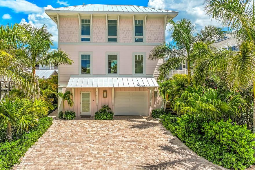 “The Boat House” is a rare opportunity to own one of Boca Grande’s most compelling newly constructed deep-water boating properties, a refined waterfront retreat purpose-built for the avid sportfishing and boating lifestyle. Completed in 2024 by Yusk Construction and interiors masterfully curated by acclaimed local designer, Sue Sligar, this custom residence delivers the increasingly rare combination of immediate Gulf access, new marine infrastructure, and elevated coastal luxury in an exceptionally efficient island footprint.  Positioned along a protected deep-water canal with no fixed bridges to Charlotte Harbor or the Gulf, the property was designed for owners who prioritize quick access to open water, effortless dockage, and turnkey boating convenience. A newly constructed seawall and exceptional dock complex create a highly functional waterfront environment tailored to the serious fisherman and boating enthusiast alike. Features include a 24,000-pound Coastal Series boat lift, expansive ENDECK synthetic decking, aluminum-framed grated platform, illuminated fish-cleaning station, shore power, freshwater service, and direct deep-water access to the harbor and Gulf within minutes.  Inside, the design aesthetic elevates the residence far beyond a traditional boating property. Refined coastal textures, nickel-gap shiplap walls and ceilings, designer wallpaper, curated lighting, brass stair railings, and bespoke cabinetry create interiors reminiscent of an elegant private yacht club...polished, timeless, and effortlessly luxurious. Andersen hurricane-impact windows and doors flood the home with natural light while delivering exceptional storm protection and peace of mind.  The chef’s kitchen was designed for elevated entertaining after a day on the water, featuring quartz countertops, custom soft-close cabinetry, and a premium appliance suite including a Liebherr refrigerator/freezer and Bosch induction range, dishwasher, and microwave drawer.  Offering two bedrooms, one full bath, and two half baths, the residence was intentionally designed to function as the ideal luxury boating retreat, guest residence, or private quarters for a captain or crew supporting a larger island estate. Elevated approximately 13’3” above base flood elevation, the structure incorporates superior construction standards including a concrete block base, advanced steel cross-frame reinforcement system, standing seam metal roof, Hardie siding and soffits, open-cell spray foam insulation, tankless electric water heater, and a 2024 HVAC system.  The pull-through garage operates as a fully equipped marine utility space complete with epoxy floors, EV charging readiness, rod storage systems, additional refrigeration, full size washer and dryer, plumbing for an ice-maker, and extensive storage for fishing gear, water toys, and boating equipment.  Technology and security are seamlessly integrated with an Alert 360 security system, Lutron lighting controls, multiple WiFi access points, security cameras, and SONOS surround sound anchored by an 85-inch Samsung television in the living room.  For the discerning Boca Grande owner seeking state-of-the-art dockage, immediate deep-water Gulf access, and a turnkey luxury residence designed around the boating lifestyle, “The Boat House” represents an exceptionally rare island offering.