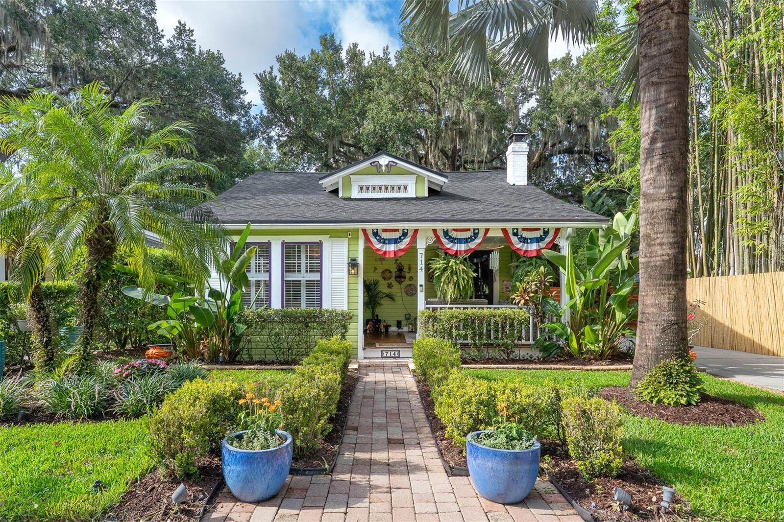 Welcome to this splendid Key West style Craftsman Bungalow situated in the Lake Davis/Greenwood neighborhood. This fully renovated and enhanced home features a welcoming front porch for relaxing enjoyment, generous living area with a wood burning fireplace, crown moldings and high ceiling. Step into the extensively remodeled (2025) chefs kitchen completed with new high end Gallery series SS appliances including a six burner/ air fry convection gas range, knotty pine tongue and groove ceiling with recessed lights and crown moldings, lighted glass cabinets, farm style sink, under cabinet lighting and center island. Both the sizable primary bedroom and large 2nd bedroom are embellished with bead board ceilings and crown moldings. Original heart of pine flooring through out. The jack and jill bathroom was completely remodeled in 2022 also with a bead board ceiling and crown moldings complimented by subway tile wainscoting and the original towel storage and hamper.
A four season sun room under heat and air which was added in 2024 offers conversational seating and dining area. Complete with six foot glass windows that slide open for an open air feeling, eight foot glass doors, solar sun shades, built in dry bar with dual zone wine refrigerator, laundry closet with an LG laundry center and storage cabinetry.
Step outside to the private tropical retreat with a new deck (2024). A majestic live oak, tropical landscaping, various seating areas, and evening ambiance lighting make this a sanctuary that is completely fenced in.
Added features are a complete rewire 2022, re-plumbed 2022, new roof 2022, new HVAC and air ducts 2022, transferable termite bonds, detached original garage converted to a shed for ample storage and so much more.