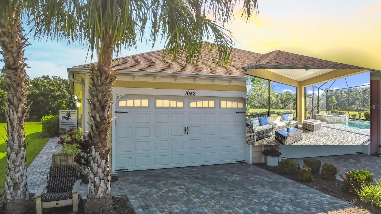 Welcome to paradise in this sought-after Key West-style Antigua Model Villa in the gated 55+ community of Latitude Margaritaville. Enjoy your own private heated pool and spa, extended screened lanai, and a private wooded backyard. Inside, you'll find engineered wood and tile flooring, crown molding, hurricane-impact windows, plantation shutters, and custom closets. The upgraded kitchen features 42'' cabinets, granite countertops, full backsplash, a large island, and upgraded appliances with a gas range. Live the resort lifestyle every day with access to a lagoon-style pool, pickleball, tennis, bocce, basketball, walking trails, golf cart paths, and a state-of-the-art fitness center with sauna, indoor lap pool, and massage rooms. Dine at the Latitude Bar & Chill or socialize at the on-site restaurant. This is your chance to enjoy laid-back luxury and vibrant community living—move in and start living the good life now! Chandelier in dining room excluded from sale
Private Remarks: Chandelier in dining room excluded from sale