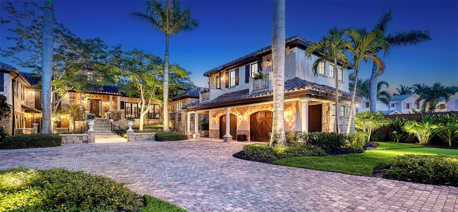 A truly exceptional waterfront retreat in one of Sarasota’s most coveted enclaves—Cedar Park Circle on North Siesta Key—this gated and private estate offers over 220 feet of prime bayfront with panoramic views of Cocoanut Bayou and Roberts Bay. Residents enjoy unrivaled boating access to the Gulf of Mexico and exclusive private deeded beach access.
Spanning over 10,600 total square feet, including 6,500 square feet under air, this architectural masterpiece features 5 bedrooms, 5.5 bathrooms, and thoughtfully designed spaces across multiple expansive levels with an optional elevator if desired. Soaring ceilings, timeless finishes, and seamless indoor-outdoor living define the home’s coastal elegance. From the welcoming arbored front patio to the impressive wood-and-iron entry, every detail invites you in.
Inside, the main living areas are designed for both comfort and grandeur. The foyer/sitting room opens to sweeping pool and bay views, while the massive great room impresses with an oversized stone gas fireplace, beamed ceilings, chandeliers, French doors, and a spacious dining area with custom built-ins. Around the corner, the newly renovated gourmet kitchen and den provide the perfect blend of everyday luxury and effortless entertaining. Here, you’ll find white-on-white custom cabinetry, quartz countertops, an 8-burner Wolf gas cooktop, dual SubZero refrigerator/freezers, a built-in Miele coffee system, and discreetly integrated conveniences like a second dishwasher and refrigerator. The adjoining den and breakfast nook boast tranquil water views, making this space an ideal private retreat.
For the boating enthusiast, the property offers 150 feet of dockage, a 20,000-lb boat lift, two jet ski lifts, and a deep-water cut-in dock accommodating a 50’ vessel. After a day on the water, unwind on the expansive travertine-tiled back terrace with its teak summer kitchen, fire pit, multiple lounging and dining areas, and a saltwater infinity pool—all overlooking the bay. Hurricane-impact windows and doors, along with a new Dam Easy flood barrier, provide peace of mind.
Private quarters are equally impressive. The luxurious master wing features his-and-her baths and closets, a dedicated exercise room or home office, and an outdoor tiled balcony—combining convenience, privacy, and resort-like amenities. On the opposite side of the home, three spacious guest suites each offer private balconies and baths. The ground floor grotto/media room with a full bar, wine room, steam bath, fifth bedroom, and two outdoor patios creates the ultimate guest haven.
Additional features include dual laundry rooms (one on each wing), an oversized two-car garage with built-in storage, additional parking within the compound, and under-house storage. Designer landscape lighting, a four-zone heating/cooling system, and meticulous craftsmanship throughout ensure this residence is as functional as it is beautiful.
This is a once-in-a-lifetime opportunity to own a one-of-a-kind sanctuary where private beach access, world-class boating, and timeless coastal luxury come together seamlessly at Cocoanut Bayou’s exclusive waterfront enclave.