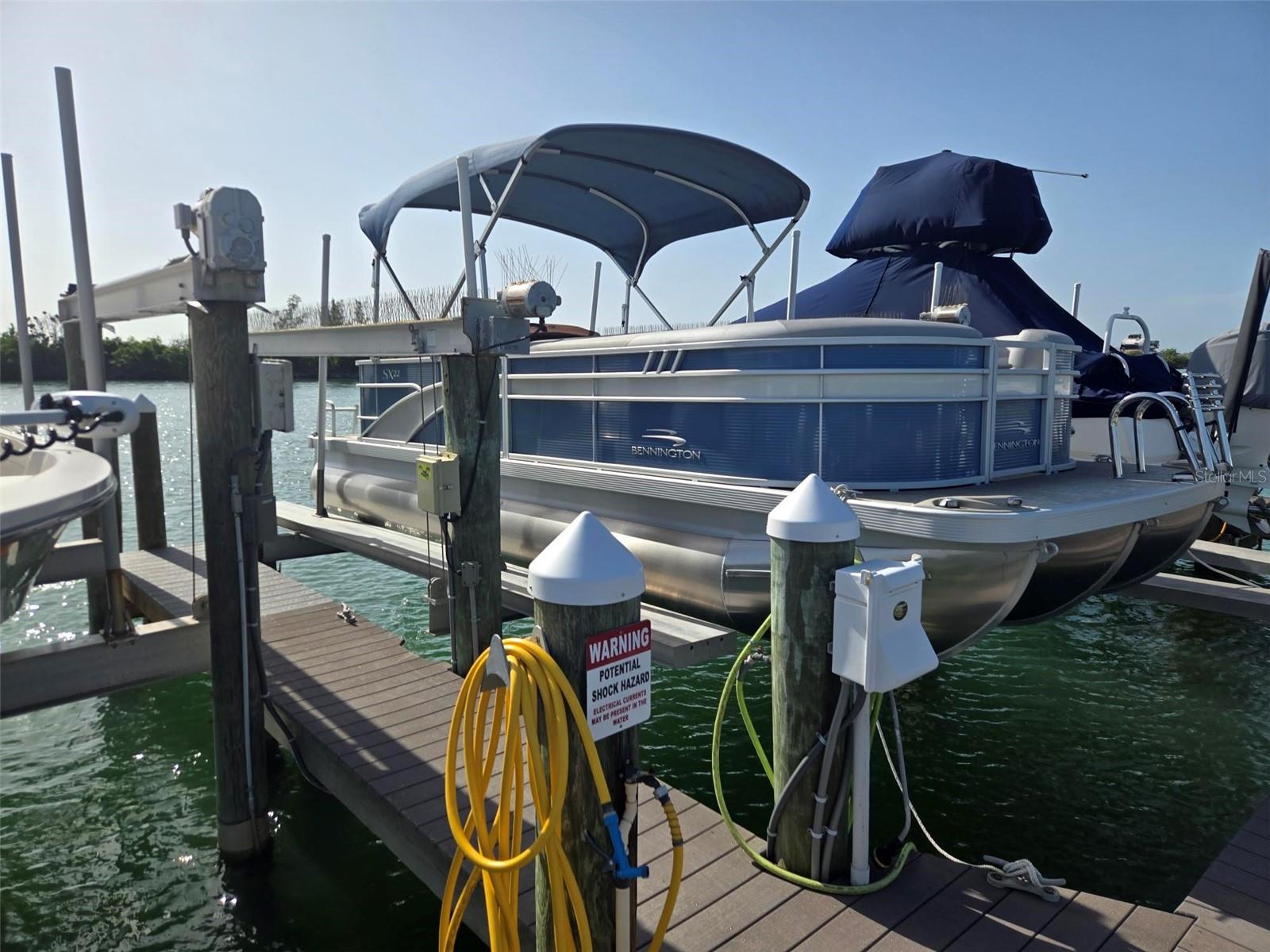 Boca Grande North Marina Boat Slip #56 includes a 12,000-pound capacity boat lift and a 2023 Bennington SX22, 22-foot tritoon (pontoon boat with three tubes) popular for day-cruising, fishing, and watersports. Yamaha 150 hp motor. All docks are made of composite materials. The Boat Slip is deeded, and you do not need to be a Boca Grande North condominium owner to purchase! Deepwater with no bridges and only minutes to the ICW and Gulf!