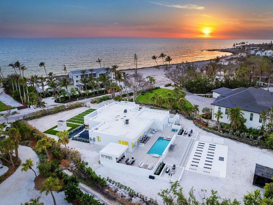 An architectural masterpiece reimagined for those with a passion for modernist living. The Ness House, named for its original owners who worked with architect Tim Seibert on a 1971 renovation, was originally built in 1961 using the innovative Lambo lithic poured concrete method developed by builder John Lambie Sr.—a pioneering example of Sarasota School of Architecture design. It features an advanced rainwater collection system and stays naturally cool with roof outlets and north-facing walls. Awarded historic designation in 2011, this waterfront retreat masterfully blends Seibert’s vision with modern, design-forward living, all in harmony with its lush subtropical setting. Set on nearly an acre with 135 feet along Heron Lagoon, the 4,006-square-foot home was meticulously renovated to enhance flow and entertaining. The minimalist yet inviting interior features large-format white tile floors, abundant skylights and seamless transitions between spaces. Clean lines, natural light and a strong connection to the outdoors define the living experience. The gallery-style foyer serves as a striking entry and an elegant space to showcase the home’s architecture and proficiency. Large solid wood and frosted glass sliding doors reveal a versatile space, currently a lounge but easily converted to an office or private guest room with its walk-in closet, floor-to-ceiling windows, built-in bookcase and separate entrance from the front door. Just beyond the private room and through the gallery, the home unfolds into the expansive family living area. The seating area, great room, and thoughtfully reimagined kitchen are designed for aesthetic appeal and everyday function. Outfitted with a Samsung induction cooktop, built-in oven and refrigerator, as well as an LG microwave, the kitchen’s minimalist composition is enhanced by a walk-in pantry featuring quartz countertops and concealed appliances, creating a seamless, gallery-like feel. A dramatic tiled counter-to-ceiling backsplash encloses an oversized picture view of nature, connecting interior life to the outdoors and beyond. The Florida room, wrapped in retractable glass, offers the ultimate flexibility—fully enclosed for intimate dinners or opened wide for breezy indoor-outdoor entertaining. The primary suite provides a tranquil sanctuary with designated seating, sleeping and dressing areas. The en-suite bath combines clean-lined surfaces with warm wood accents, stone countertops, a soaking tub, and a walk-in shower, creating a spa-like ambiance. Three well-appointed guest bedrooms include two with private courtyards, one features an en-suite bath, while the other two share a beautifully designed full bath. Designed for entertaining, the home’s open gathering spaces flow seamlessly to a striking outdoor setting with a covered kitchen, bar seating, grill, beverage area, spacious lounge and dining zones, and an open-air space for yoga, meditation or evening soirées. True to its roots in the Sarasota School’s philosophy, the feeling of being outside when inside the home is seamless. Native landscaping, shell-inlaid hardscape, and a one-of-a-kind Ipe wood treehouse are thoughtfully designed to withstand the test of time. In the gated Sanderling Club—a private enclave with 24-hour security, a private beach and marina access—The Ness House is a celebration of art, architecture and the Florida lifestyle at its most refined.