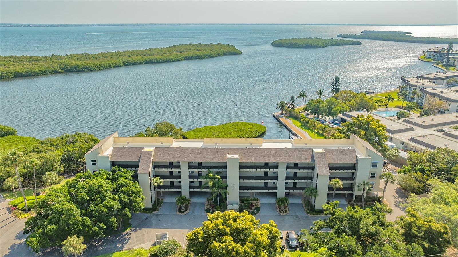 EXQUISITE WATERFRONT PENTHOUSE CONDO WITH STUNNING WATER VIEWS FROM EVERY WINDOW
Nestled in the heart of a vibrant Longboat Key Community, this stunning 2-bedroom, 2-bathroom condo offers unparalleled water views of Sarasota Bay, creating a perfect backdrop for both sunrises and sunsets. The moment you step inside, you'll be captivated by the breathtaking scenery and the spacious design that blends coastal living with sophistication. Beautifully renovated with brand new floor-to-ceiling hurricane windows, this condo seamlessly integrates the living and dining areas with an open kitchen featuring stone countertops, custom cabinets and stainless-steel appliances. The light filled Primary Bedroom boasts two closets, one being a walk in complete with built-in ample storage. Take in manatee and dolphin viewing from the expansive sunny Florida Room or relax in style looking out the huge picture window of your living room. This move in ready tastefully appointed condo located in the amenity rich 26-acre Windward Bay Neighborhood offers an engaging lifestyle that includes 2 marinas with 28 boat slips, 2 Kayak launches and racks, a fishing pier and Deeded Beach Access making it a paradise for water enthusiasts. Include two pools, 4 community firepits, tennis and pickleball courts, Fitness Center, library and community clubhouse with a catering kitchen and you have the perfect recipe for unparalleled waterfront living. Don't miss the opportunity to own a piece of paradise with stunning water views and a vibrant community atmosphere. Peace of mind is assured as ALL SPECIAL ASSESSEMENTS HAVE BEEN PAID IN FULL. Contact us today to schedule a showing!