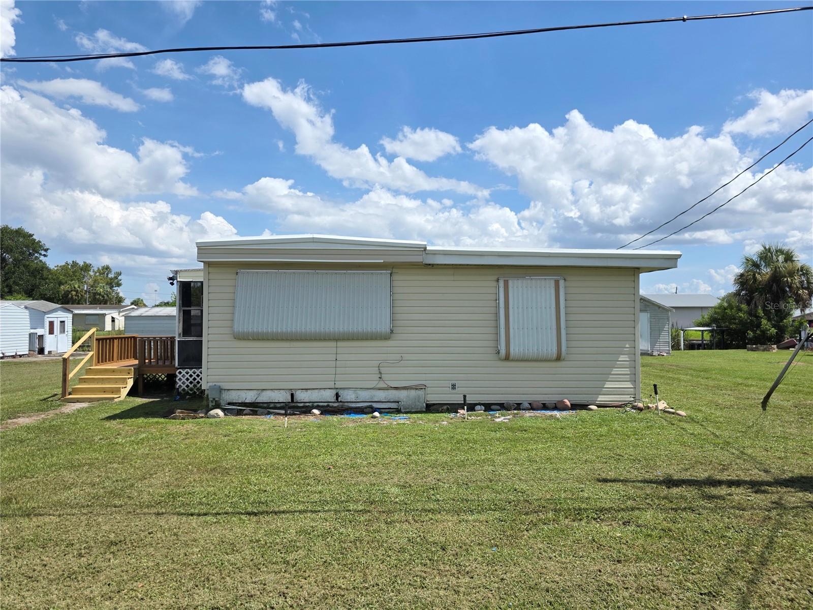 LAKE OKEECHOBEE ACCESS - 2/2 SWMH, it is furnished, It has a roofover, AC was serviced April 20, 2025, 15 minutes to Lake Okeechobee, Aluminum Seawall. This is a cute, furnished mobile home with a lot of potential. It is spacious and plenty of storage. Two Sheds.
Come and take a look. A great buy.