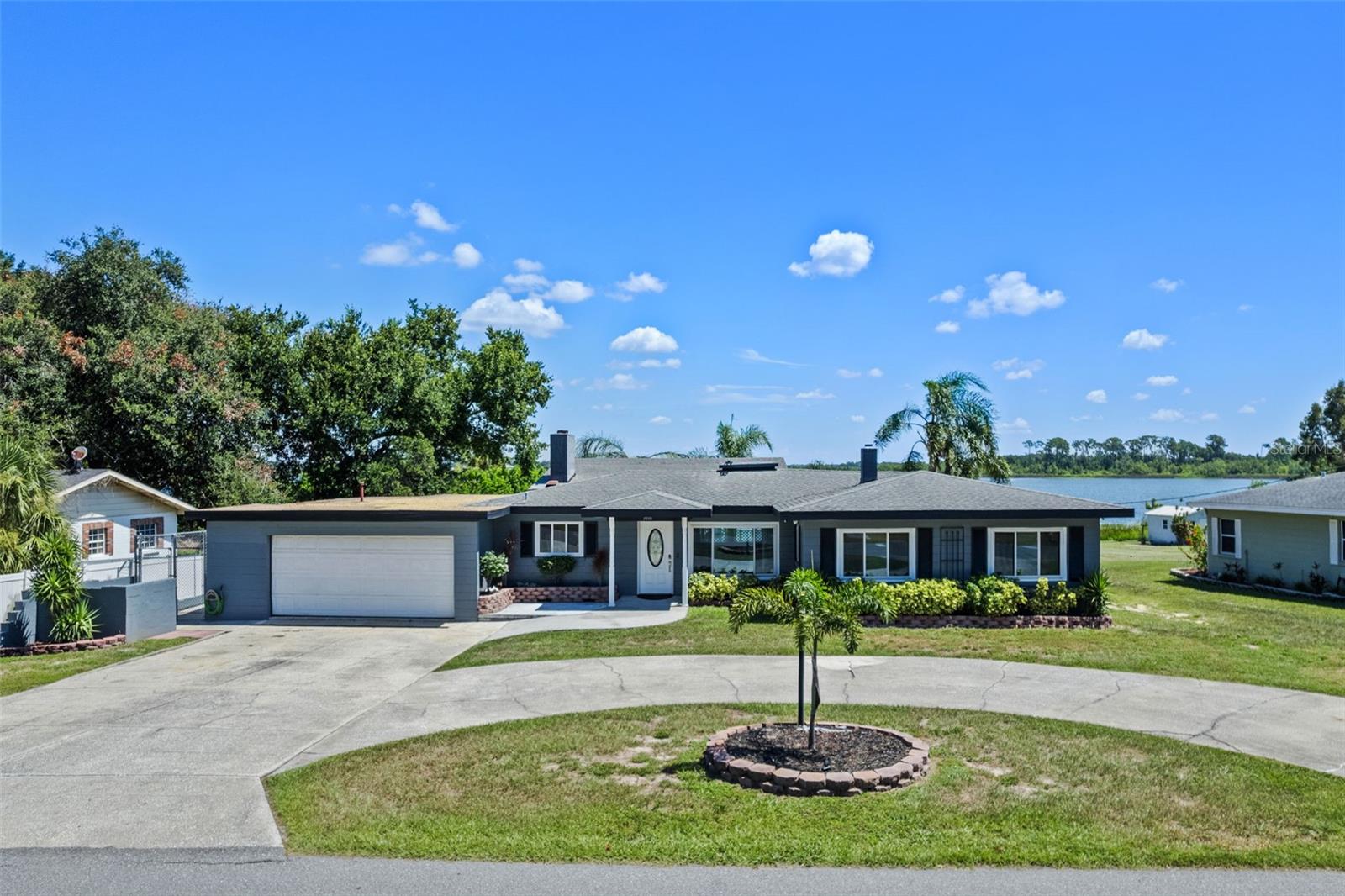 Welcome to lakefront living on Winter Haven’s world-famous Chain of Lakes. Set on a .44-acre lot with a beautiful, wide-open view of Lake Jessie, this 4-bedroom + den/office, 2-bath home blends an open, glass-lined design with the best of indoor–outdoor Florida living.
Inside, a large family room with bar anchors the home—perfect for game day and gatherings—complete with a wood-or-gas fireplace and a built-in indoor gas grill. A wall of glass with 12-ft ceilings and five sets of sliding doors frames the lake and opens to the pool deck. The plan also features an eat-in kitchen with breakfast nook, a separate dining room, a spacious foyer, and hardwood floors throughout.
Step outside to your expansive back patio with pool and ample space and electric power for a hot tub, then down to the water’s edge where a partially finished double boat dock (with electric & water already run), twin electric boat lifts, and a single jetski lift await your finishing touches. A 2-car garage provides excellent storage for toys and tools.
Lake Jessie connects to 22 navigable lakes on the Winter Haven Chain, giving you endless days of boating, fishing, watersports, and dock-and-dine options across town. Aviation and adventure lovers will especially appreciate being on the same lake as Jack Brown’s Seaplane Base & School, a beloved Winter Haven landmark—watch the splash-and-goes from your backyard or take a lesson and see the Chain from the sky.
If you’ve been waiting for a true lakefront lifestyle with huge potential on the Chain, 1016 Biltmore delivers the view, the water access, and the room to make it your own. Schedule your showing and come see the possibilities.
