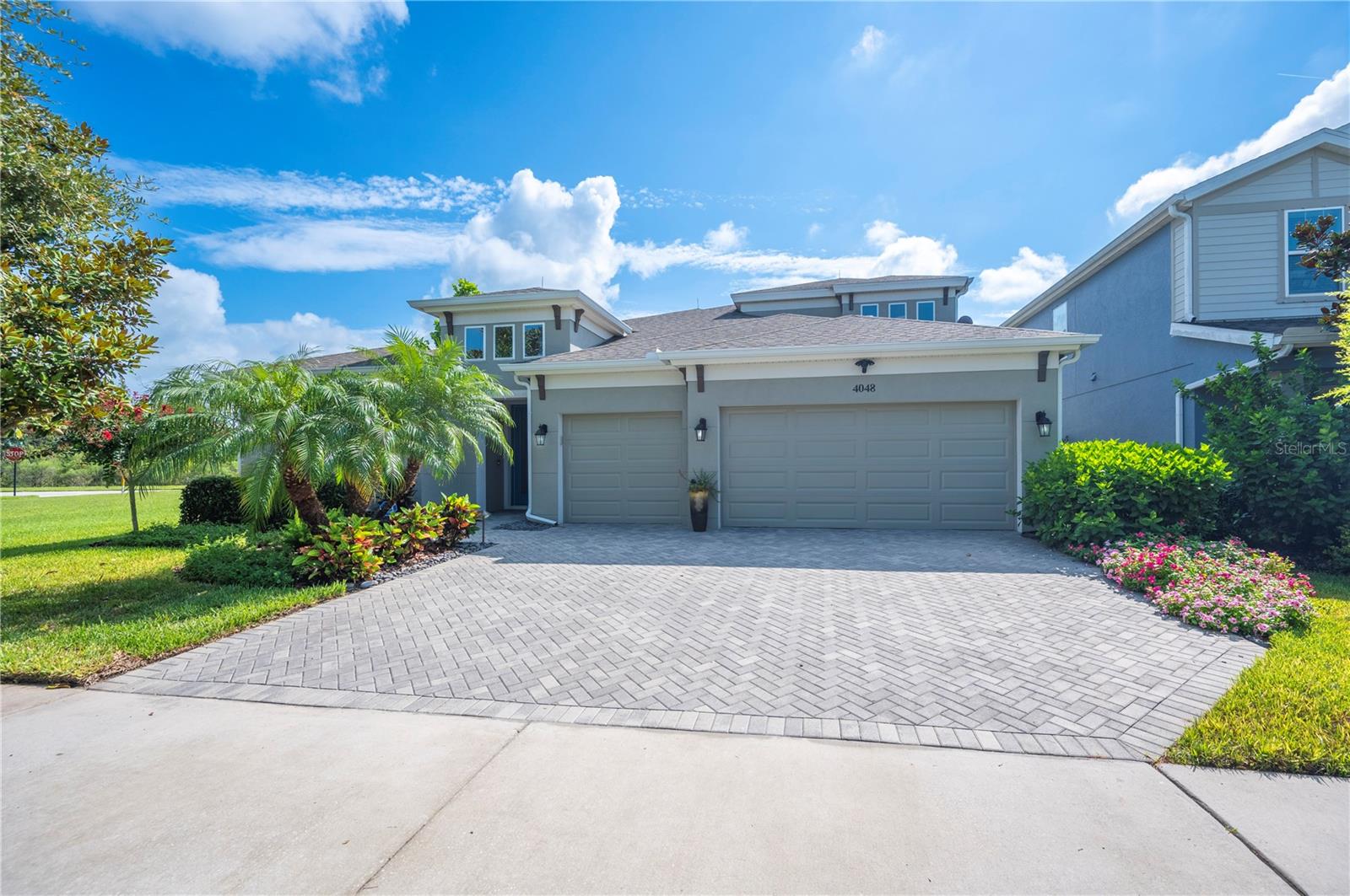 Welcome to this stunning West Bay home located in the award-winning Bexley neighborhood! This beautiful Bayshore II floor plan offers 4 bedrooms + Bonus Room, Office and 4 Full Bathrooms with an incredible open layout that is perfect for modern living. This Executive home is nestled on a serene lot with mature landscaping and only 1 side neighbor. This stunning home greets you with Upgraded leaded glass 8-foot double doors and a grand entrance featuring soaring 11'4" ceilings, making a statement as you enter this beautiful home. This home features incredible wood grain tile flooring, tray ceilings, 5 ¼ inch baseboards and crown molding. As you step into the kitchen and dining area, you are immediately captivated by breathtaking views of the gorgeous pool and custom landscaping. The Gourmet Kitchen is a chef’s dream, equipped with Quartz countertops, custom hood, walk-in pantry, built in kitchen table, and stunning pendant lighting. The oversized Kitchen Island provides ample space for gatherings and family dinners, flowing seamlessly into the Grand Room, creating an ideal space for entertaining. This Grand Room has a gorgeous feature wall defining the family room with both warmth and sophistication and designer lighting creating the perfect space for entertaining. The walls of glass open to an oversized lanai and custom heated saltwater pool offering a peaceful outdoor oasis. The luxurious Primary Suite features custom his and her closets, large walk-in shower and views to the lanai and serene pool. Your new home includes two additional Bedrooms downstairs, each with its own Full Bath, a Den/Office space perfect for remote work, and a spacious upstairs Bonus Room with a Bedroom and Full Bath, ideal for hosting guests. This meticulously designed home is truly turn-key and offers a rare opportunity to own a model-caliber home in one of the most sought-after communities in the area. (Additional highlights included on a separate feature sheet). Don’t miss out on this extraordinary property!