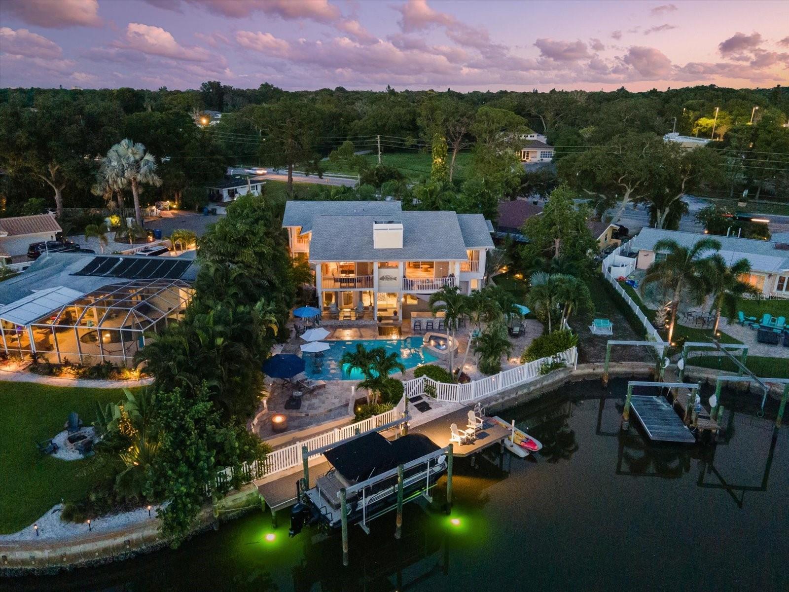 Indulge in a true WATERFRONT PRIVATE OASIS. This exemplifies luxurious gated coastal living with spectacular water views from every room in this magnificent home. This split-level residence features 3 bedrooms, 4 baths, a 2-car garage, and over 2,500 sq.ft. of exquisite travertine decks. Upon entering, the lower level invites you to a bonus living room with a custom wet bar, ideal for entertaining. This level also includes a full bath and an oversized two-car garage for convenience.
Upstairs, the elegant living room boasts a wood-burning fireplace, vaulted ceilings, plantation shutters, and balconies that overlook the serene waters. Adjacent to the kitchen, a spacious dining room with its own balcony provides the perfect setting for meals with a view. The kitchen itself offers a charming bay window "eat-in" area, showcasing even more stunning water vistas. The primary bedroom is a tranquil retreat, featuring laminate floors, vaulted ceilings, and large windows that allow abundant natural light to pour in.
Enjoy a huge pool with a spillover spa and a sun shelf that comfortably accommodates the whole family. Multiple seating areas, another custom bar, and a fire pit area make for delightful evenings. The dock has been upgraded with Trex decking and includes a 16K boat lift, providing quick and easy access to the Intracoastal Waterway.
Additional features of this home include a custom turf putting green and expansive deck space perfect for outdoor dining, lounging, and enjoying breathtaking sunsets. The custom bar areas, both indoors and outdoors, create ideal spaces for hosting gatherings. Elegant interiors with vaulted ceilings, plantation shutters, and premium finishes throughout the home add a touch of sophistication to every room. The convenient location offers close proximity to local amenities, shopping, dining, and recreational activities, making it easy to enjoy the best of coastal living.