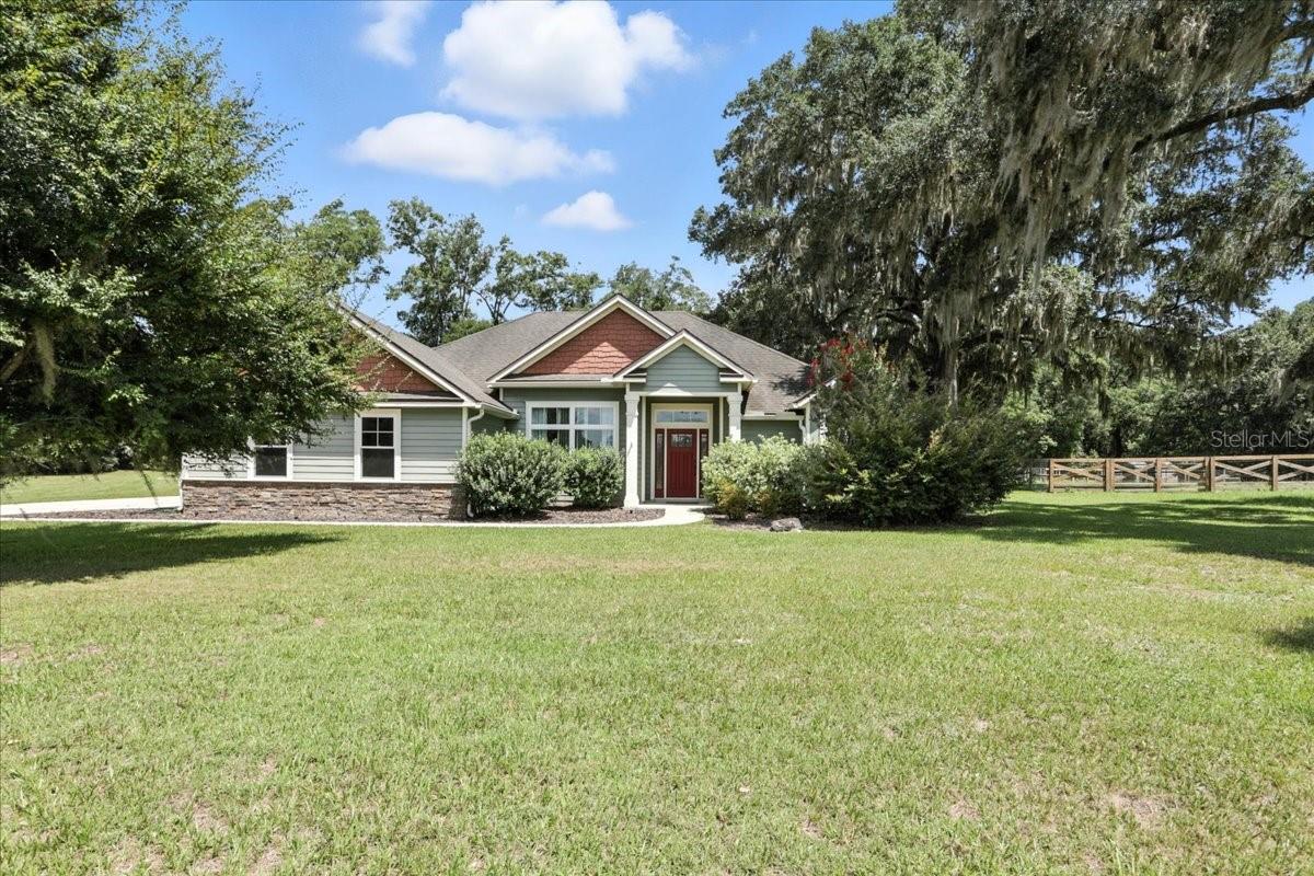Back on the market due to Buyer's financing issue... Upscale Country Living in Gated Cinnamon Hills Estates. Welcome to this beautifully appointed fully upgraded 3-bedroom, 2-bathroom home located on a quiet cul-de-sac. Set on over an acre and bordered by a lush wooded tree line, this home offers the perfect blend of upscale living and natural tranquility - just minutes from Ginnie Springs, Poe Springs, and the Santa Fe River. Step inside to discover an open-concept layout with a split-floorplan, designed for both comfort and functionality. Engineered hardwood floors flow throughout the main living areas, while plush carpet adds warmth to the bedrooms. High ceilings, crown molding, tray ceilings, and elegant lighting add to the home’s elevated feel. The luxurious primary suite is filled with natural light and boasts a tray ceiling, large walk-in closet, and a spa-inspired en-suite bathroom complete with a soaking garden tub, dual granite vanities, and a dual-head walk-in shower. Additional highlights include two well-appointed guest bedrooms, a comfortable guest bath, and a large laundry room with built-in table and utility sink for added convenience. The upgraded kitchen features granite countertops, stainless steel appliances, an ample pantry, and a seamless connection to the living and dining areas - ideal for entertaining or everyday family living. French doors lead to a screened back patio where you can enjoy the serene backdrop of mature trees and Florida’s natural beauty. The expansive 1.1 acre lot backs up to a wooded tree line for added privacy, and the attached oversized 2 car garage offers not just parking, but also plenty of space for tools, bikes, or weekend projects. Enjoy the quiet charm of upscale country living while staying close to all the adventure North Florida has to offer. With easy access to I-75, commuting to Gainesville, Alachua, and surrounding areas is a breeze. Home has been approved for appraisal waiver and Seller is offering a credit of up to 1 discount point to help lower the buyer's interest rate (subject to lender approval). Don’t miss your chance to own this exceptional home in one of High Springs’ most exclusive communities, and enjoy year-round fun at some of the world's best springs and rivers.