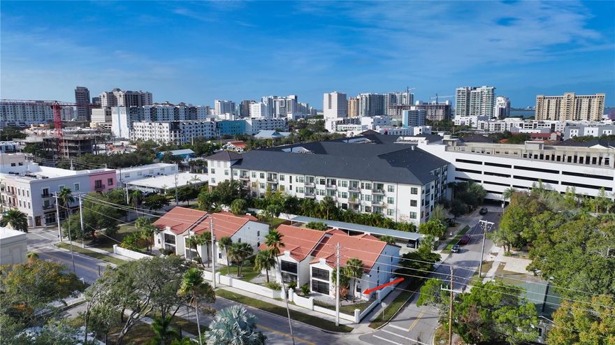 Live affordably downtown! In the heart of the Rosemary District, Unit #107's walkability score of 92 makes it a Walker's Paradise. This first floor, corner two-bedroom, two full-bath condo is in Mentone Court, a charming 16-unit complex. Covered assigned parking is 50 feet away and it comes fully furnished with a 75" Frame TV, leather power recliner couch and most of the furniture and artwork pictured. The lanai leads out to private green space – rare at any price in the city – walk through the front gate walk half a block to four restaurants at beautiful Rosemary Square (see pictures). Whole Foods and the Lido Beach trolley, which leaves every 20 minutes, are within four blocks. Main street is just a five-minute walk. Residence 107 was renovated last year with new plumbing, paint, AC/heat, ceiling fans, modern large format porcelain tile flooring with 5" baseboards and plantation blinds on all windows. Everything is fresh and new. As a corner unit with high ceilings the space is bright and airy. The new Samsung smart (Wi-Fi) appliances include an induction range and ultra quiet dishwasher, never used. Quartz countertops complement solid hickory cabinets with dovetail joinery that won’t delaminate. The backsplash and island are clad with hand-made Moroccan Zellige tile by Cle. Gorgeous designer tile surrounds the oversized guest shower and the primary en-suite bath's shower, which has a 3/8” heavy frameless glass door; both have Kohler Awaken hardware and designer Choreograph shower barres.  The included, new high efficiency LG ventless heat pump stacked washer/dryer is ready for your beach towels. An oversize 5'x13' lanai has a storage closet and is protected by a 12' wide motorized roll-down Kevlar storm/sunscreen rated to withstand a Cat. 5 hurricane; its magnetic-track system means no sagging. Mentone Court's block buildings with tile roofs are not in a flood zone and have never any storm damage. Professionally managed, the association dues are only $522/month which funds the reserve and covers master insurance on the structure as well as water, sewer, trash, landscaping and exterior maintenance. The building is under three stories and is exempt from Milestone Inspections, and the community's mandated high reserves are funded through special assessments. One-week minimum rentals and smaller pets are permitted. Unit 107 is a move-in-ready city pied-a-terre, offering the option to live full-time downtown in affordable luxury and walkability to the best of Sarasota.