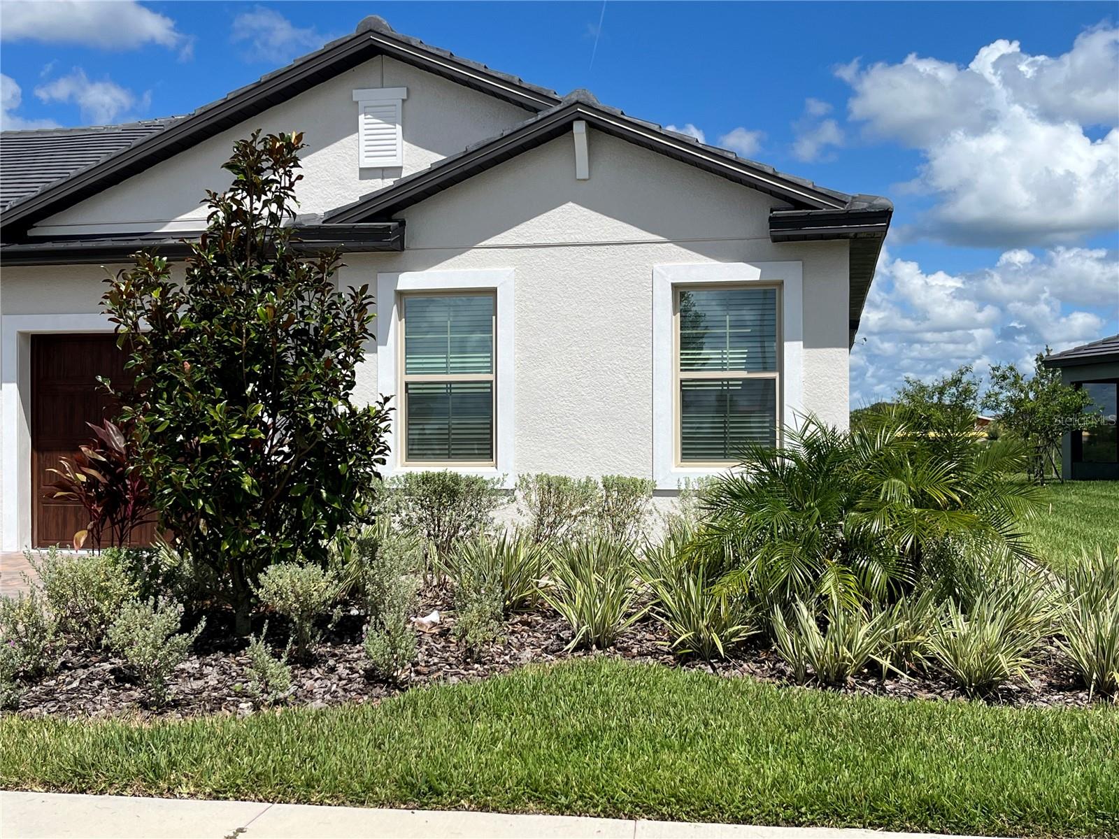 Nestled within the gorgeous Medley, an Active Adult gated community (At least 1 tenant must be 55+) in the serene and beautiful Mirada a MetroPlaces development in San Antonio, one of the fastest growing cities of the Pasco county. Situated in the stunning master-planned world class Mirada lagoon community, the Dayspring II* model a corner unit is a 2 bed 2 bath with a flex space. offers the convenience of single-story living, with two generously sized bedrooms, including a private owner's suite with a serene pond view that boasts an ensuite bath, and an expansive walk-in closet. The villa’s open floor plan seamlessly transitions from the well equipped kitchen, featuring upgraded kitchen cabinets, stone countertops, and stainless-steel appliances, into the spacious living and dining areas. Step out onto your private screened in lanai to unwind with a glass of wine under the evening sky or wake up to the breathtaking sunrise while enjoying your favorite breakfast beverage. This beautiful villa comes with ceiling fans in every room, separate laundry room with a washer, dryer, and cabinets for additional storage space. As a member of the Medley at Mirada Homeowners Association, residents have access to a private resort-style pool, clubhouse with indoor and outdoor dining options, a bar, fitness center, card room, tennis and pickle ball courts, bocce ball, shuffleboard, and two dog parks. The HOA fee covers exterior painting, lawn maintenance, cable and high-speed internet. Additionally, residents can take advantage of the largest lagoon in the nation, offering a beach lifestyle complete with swimming, kayaking, paddleboarding, and even a swim-up bar. Medley at Mirada is a golf cart friendly community with multi-modal paths and nature trails, perfect for walking, biking, and bird watching. With its tranquil settings, unparalleled amenities and prime location just minutes away from I-75, multiple shopping centers, restaurants, and a short drive to downtown Tampa and many more.