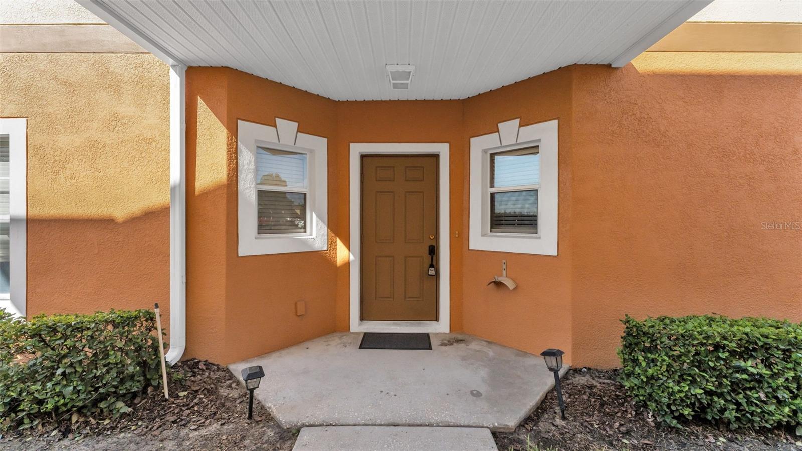 This spacious 4-bedroom, 3-bathroom townhouse is located in the highly desirable gated community of Autumnwood Grove, just moments from Polk State College, the Polk Parkway, Publix, and plenty of dining options. With a community pool and clubhouse for residents and guests, this neighborhood offers both convenience and lifestyle. Inside, the ground floor features a bedroom and full bathroom, perfect for guests or multi-generational living. The kitchen showcases light oak cabinetry, a walk-in pantry, and a dining space, all overlooking the living area with durable tile flooring in wet areas and laminate wood-look flooring throughout. Sliding glass doors lead to the screen-enclosed lanai with storage and views of a buffered, landscaped backyard. Upstairs, the primary suite offers its own private bathroom, while two additional bedrooms—equivalent in size—share a full guest bath. The laundry room is conveniently located upstairs as well. Bedrooms feature carpeting for comfort, with tasteful accent walls and pops of color adding character throughout. Whether you’re relaxing on the lanai, entertaining at the clubhouse, or enjoying the community pool, this townhome offers the perfect combination of comfort, functionality, and location.