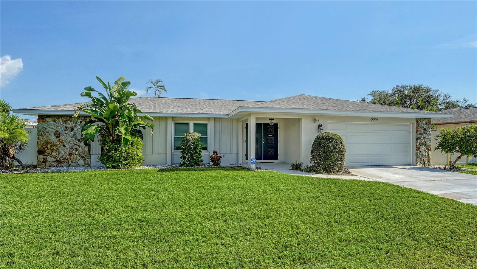 Welcome to this beautifully updated home a mere 7 miles to the pristine beaches of Anna Maria Island. This home offers the perfect blend of convenience and coastal lifestyle. Inside, you will find an open floor plan that lives big with a spacious layout, a stylishly renovated kitchen, and bathrooms that have been tastefully updated. Neutral tones, fresh paint, and thoughtful touches throughout create a move-in-ready space ideal for everyday living or entertaining. Step outside and enjoy a brand-new lanai and fully fenced yard with ample room for outdoor living, gardening, or pets. Recent Updates Include: New roof (2025), new side door in garage (2025), new stone countertops (2025), custom kitchen cabinetry (2025), new carpet in 2 bedrooms (2025), interior paint (2025), HVAC (2021), water heater (2022), washer/dryer (2020). Schedule your private showing today!