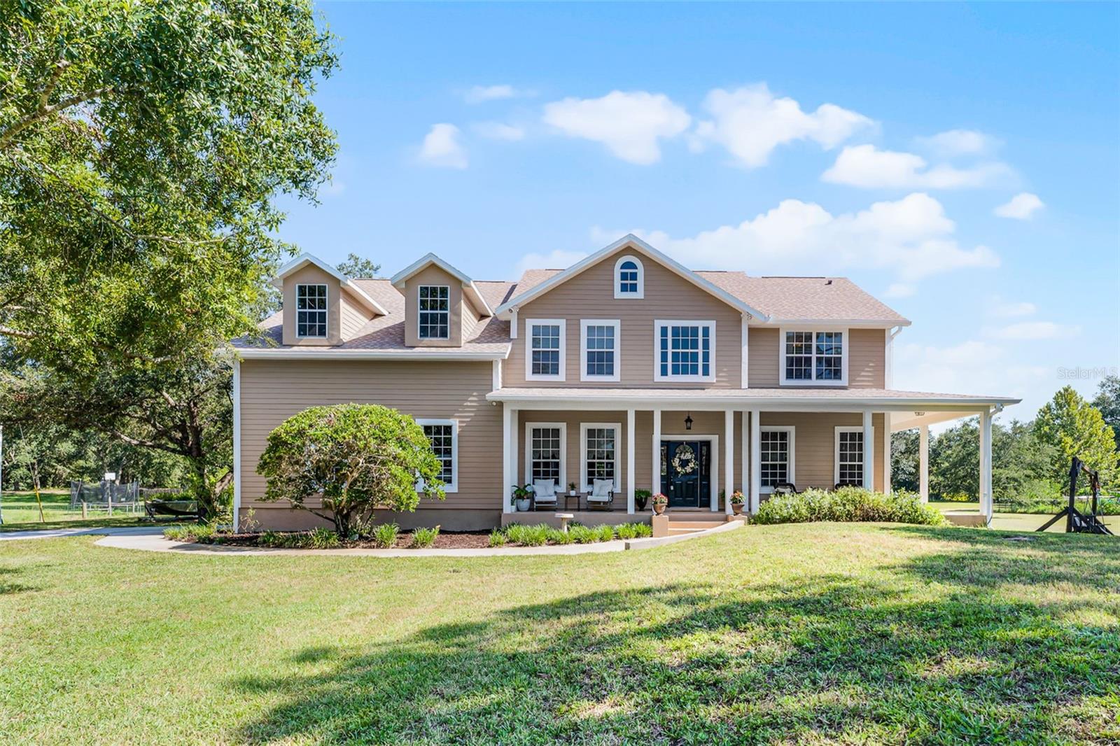 Imagine living in this custom-built home set on two acres giving that country feel, yet conveniently close to city amenities. Inside, you will find a spacious family room ideal for gatherings and relaxation. There is a bonus room located downstairs, ideal for work from home needs, and a bonus room upstairs great for hobby or study retreat. With five bedrooms and three bedrooms, this home comfortably accommodates family and guests. The primary bedroom serves as a large, spacious haven with an en suite bathroom. Outside, an oasis awaits, offering plenty of room for a garden and fruit trees. If you're an outdoor enthusiast, there is plenty of room for your boat, RV, or storage sheds, and a golf course nearby. The location offers easy access to Orlando International Airport, beaches, downtown Orlando, and amusement parks. Recent updates to the property include a new roof installed in 2025, providing peace of mind and protection, new exterior paint 2025, and new carpet 2025. This custom built home is a rare find, offering both the serenity of country living and the convenience of city life. Schedule your appointment today.