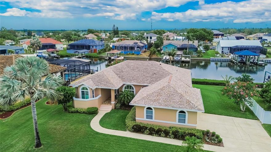 APOLLO BEACH WATERFRONT – NICELY UPDATED CUSTOM-BUILT EXECUTIVE POOL HOME – NO CDD OR HOA FEES: Live like you're on vacation and experience year-round waterfront living in this beautifully updated custom-built executive pool home, ideally located in the highly desirable Golf & Sea Village community. Perfectly positioned on a high-elevation oversized lot with 100 feet of canal frontage, this exceptional property offers panoramic views of the St. Andrews Canal and offers the ultimate Florida boating lifestyle. Your waterfront adventures begin right from your backyard with a large composite dock and a 10,000 lb. boat lift, providing quick and easy access to Tampa Bay, the Gulf of Mexico, and beyond. Designed with both comfort and entertaining in mind, this bright and spacious 3-bedroom, 2-bath home offers 1,976 square feet of living space along with an oversized side-entry 2-car garage. As you step through the double front doors, you’re welcomed by soaring 10-foot ceilings and abundant natural light that highlight the open-concept great room, dining area, and kitchen within the thoughtfully designed split-floor plan. The recently remodeled chef’s kitchen is the centerpiece of the home, featuring stainless-steel appliances, white solid wood soft-close cabinetry with 42-inch upper cabinets with crown molding, gleaming quartz countertops, breakfast bar seating, and a stylish custom tile backsplash. Its seamless flow into the dining and living areas creates the perfect atmosphere for gatherings and everyday living. The great room provides a warm and inviting space to relax while enjoying stunning water views. The spacious primary retreat offers abundant natural light, plenty of room for a king-size bedroom set, private access to the outdoor living area, and his and her closets. The luxurious en-suite bath features double vanities with granite countertops, solid wood cabinetry, a freestanding soaking tub, a water closet, and a beautifully designed walk-in shower. Secondary bedrooms are bright and spacious and feature oversized closets, while Bedroom #3 offers private access to the outdoor living area. A conveniently located guest bath and a well-appointed laundry room add to the home’s functionality. Real wood flooring throughout the main living areas enhances the home’s warmth and elegance. Step outside to your private tropical oasis, where the true essence of Florida living comes to life. The outdoor living space features a beautiful heated pool surrounded by stone pavers, a spacious covered lanai, and a fully functional outdoor kitchen ideal for dining and entertaining. The covered lanai opens seamlessly into a large screened enclosure, creating the perfect setting for relaxing days and unforgettable evenings by the water. Mature trees and lush landscaping complete the setting. SAVE MONEY: WELL WATER AVAILABLE FOR IRRIGATION. Located with convenient access to everything the Tampa Bay area has to offer, this exceptional waterfront property combines luxury, comfort, and boating convenience in one remarkable home. Come embrace the ultimate waterfront lifestyle and make your Florida dream a reality.