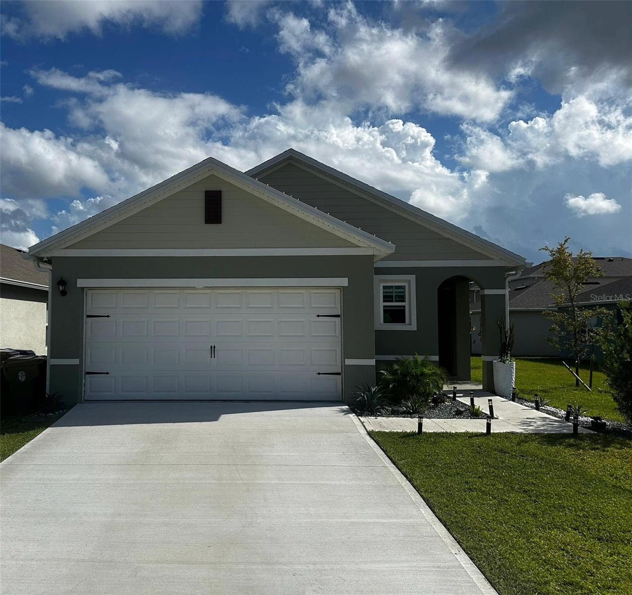 This 2023-built 3-bed, 2-bath home with a 2-car garage offers stylish upgrades and flexible living. Features include luxury vinyl flooring, new kitchen and bathroom countertops, updated faucets, and a mini-split AC in the garage? Ideal for a gym or workspace. Located in a resort-style community with a clubhouse, fitness center, pool, tennis courts, park, and playground