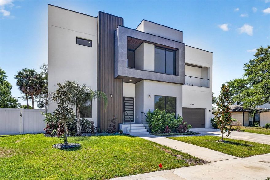 Welcome to South Tampa where convenience is a Lifestyle. Perfectly positioned within walking distance to Kenneth E. Adum Pre K-8 Magnet School, Jan Platt Public Library and local favorites Dairy Joy, Westshore Pizza, and Green Iguana. World-class shopping and dining await just minutes away at International Plaza and Hyde Park Village, while TIA ensures seamless air travel for business or pleasure. This newly constructed home (2025) has impeccable craftsmanship and design. Four luxurious ensuite BRs, while a downstairs office or fifth BR offers flexibility. A dedicated media room with beverage bar offers a cinematic experience. The  breathtaking two-story foyer makes an unforgettable first impression, framed by imported Italian large-format tile, glass-enclosed wine bottle display and a sleek linear fireplace that defines the living and great room. The kitchen is a statement of beauty and performance; featuring floor-to-ceiling custom cabinetry, a striking quartz waterfall island and premium appliances by Electrolux, JennAir, Whirlpool, Zephyr, and InSinkErator. Thoughtful enhancements such as hidden storage, a deep SS sink, breakfast bar and a 53-bottle wine refrigerator complete this culinary centerpiece. The primary suite is a sanctuary of scale and serenity, offering a grand bedroom, dressing area and a spa-inspired bath. Unwind beneath dual rainfall showers, relax in the soaking tub, and enjoy the convenience of dual vanities, linen storage, and expansive custom walk-in closets tailored for the most discerning wardrobe. Seamlessly blending indoor and outdoor living, the home’s exterior spaces are equally captivating. Out back a fully equipped outdoor kitchen with sink, refrigerator, and Spires SS gas grill, creates the perfect setting. The resort-style pool and spill over spa, finished with travertine decking provides a private oasis for relaxation and leisure. Completing this exceptional residence are advanced smart home capable features, professionally designed landscaping and lighting, irrigation system and Jandy pool equipment with AquaLink app integration, delivering both beauty and intelligent convenience. This is more than a home; it is a refined lifestyle, meticulously crafted for those who expect nothing less with South Tampa convenience. Some pictures virtually staged.