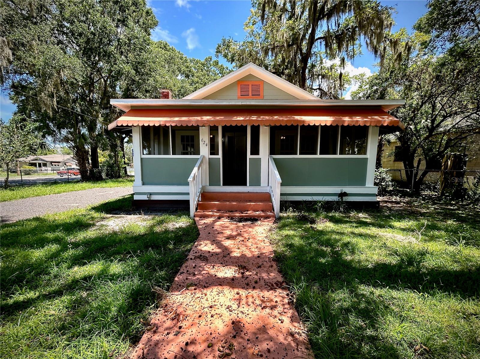 Adorable 1946 cottage-style home with vintage craftsmanship and modern upgrades on a fenced corner lot in Starke! Don’t let the age fool you; this cute home would make a great residence, investment, or rental. Notable features include a new roof, flooring, insulation, hot water heater, toilet and vanity, doors, and light fixtures. You will also find fresh paint indoors and out, and modernized electric and plumbing. Stepping indoors from the welcoming screened-in front porch you will find yourself immersed in the spacious living room’s natural light streaming through the big windows. A seamless flow will lead you into the large eat-in kitchen. Three generously-sized bedrooms provide comfort, privacy, a warm ambiance, and built-in closets. Additional bonuses are the convenient indoor laundry space and lovely covered porch off the kitchen. Whether you envision chatting with friends on porch rocking chairs or cooking with family in the large kitchen, this charming home combines the nostalgia of yesteryear with desirable contemporary updates. Located in a neighborhood of cottages and quaint homes, the property is within a mile of the historic downtown with its schools, colleges, restaurants, shops, and 1940s-era movie theatre. HCA Florida Starke Emergency is also close by. The town of Starke, situated in the heart of North Central Florida, is less than an hour southwest of Jacksonville and 30 minutes northeast of Gainesville. If you love the idea of small town living in a home with vintage charm, are looking for an investment with future potential, or would like to own a rental that could fetch about $1,500/month, give us a call to schedule a private showing before this unique opportunity is gone!