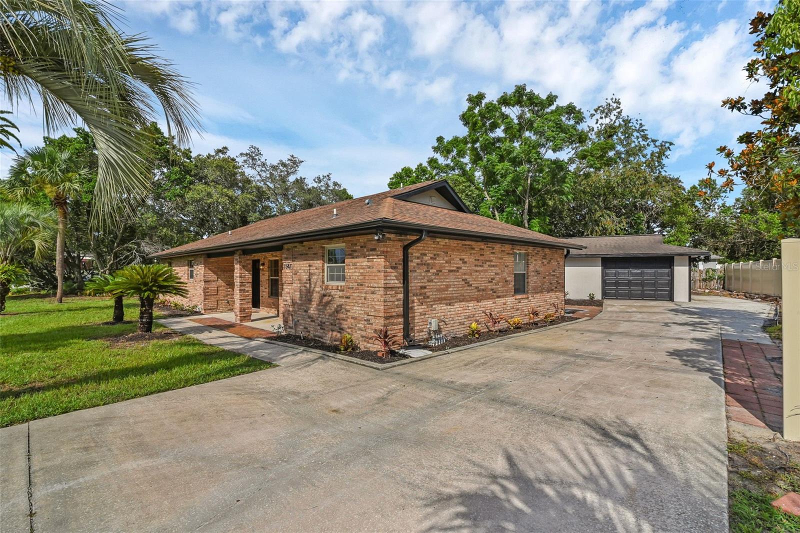 Welcome to your brick beauty in Deltona Lakes! This charming 3-bedroom, 2-bath home offers over 1,700 square feet of living space and sits on a spacious 0.30-acre lot. The layout includes a bright living/dining room combo, a cozy fireplace, and a galley-style kitchen with ample cabinet space. The primary suite features a walk-in closet and private bath. With laminate flooring throughout, ceiling fans, and fresh curb appeal, this home is move-in ready. Enjoy added comfort and peace of mind with a new AC, gable vent fan, and no HOA. Conveniently located near schools, shopping, and major highways — don’t miss your chance to make this your new home!