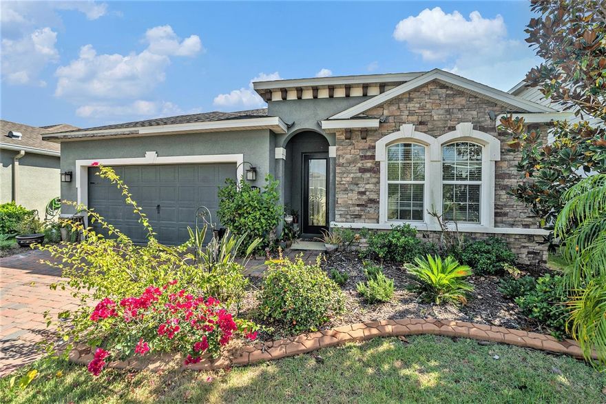 3.6% Assumable FHA Rate with Roam! Welcome to the serenity of this 5-year-old custom-built home in the highly sought-after Lucaya Lake Club community in Riverview's South Shore area of Tampa Bay. This “oasis” home, with over $30,000 in upgrades, was selected for its oversized lot, uncrowded location backing onto private woods, and sunlight-optimized orientation. Blending modern and classic designs with comfort, privacy, and functionality, it's ideal for growing, multi-generational, or retiring families. Exterior highlights include palm trees, custom stone veneer, unique accents, brick-paved driveway, and cement bed borders. Enter via the Chinchilla beveled-glass door, dramatically flooding the home with sunset colors. Step into the cool, ceramic-tiled foyer with vaulted ceilings that opens to 2,022 sq ft of airy, open-concept living. The great room features morning-sun-filled windows and a gourmet kitchen with granite countertops and island, 42-inch-high nutmeg cabinetry, corner pantry, and 5-burner gas stove—perfect for entertaining. Rest easy with 3 large bedrooms plus an oversized convertible bonus room (also LVP flooring, and ceiling fan, plus double French glass doors). Three full baths offer choices: the owner’s suite with garden-style soak tub, spacious walk in glass shower, dual vanity, and massive walk-in closet (doubles as hurricane shelter with Guardian panel); one bathroom features a minimal-lip walk-in (accessible) 5 x 3-foot shower; and the 3rd bath with a traditional tub/shower combo located in the 3rd bedroom dedicated hallway that also includes washer/dryer closed area. A tankless gas water heater provides endless hot water. Flow from the great room to the outdoor living room, 176+ sq ft screened lanai with pitched roof for stargazing and steel doggy door. A 6-foot privacy fence frames forest views; the oversized backyard could easily fit an inground pool if desired. The 2-car garage has app control and sprinkler system board. Lot perks: on-lot fire hydrant and streetlight. This home is storm-proven & ready with 150-mph rating, labeled hurricane shutters, underground utilities, in-place shelter area, whole-house surge protection, and impact-resistant windows. Lucaya Lake Club is a gated, all-natural-gas community with resort-style amenities: clubhouse, fitness center, splash park, playground, pool and access to 78-acre lake with beach, party, and picnic area. In Tampa Bay's Southeast Hillsborough County, enjoy tranquility plus easy access to highways, amusement parks, Manatee Viewing Center, beaches, top schools, shopping, and dining. This home checks every box: upgrades, space, and premier amenities. Schedule your private tour today and embrace Florida living at Lucaya Lake Club!