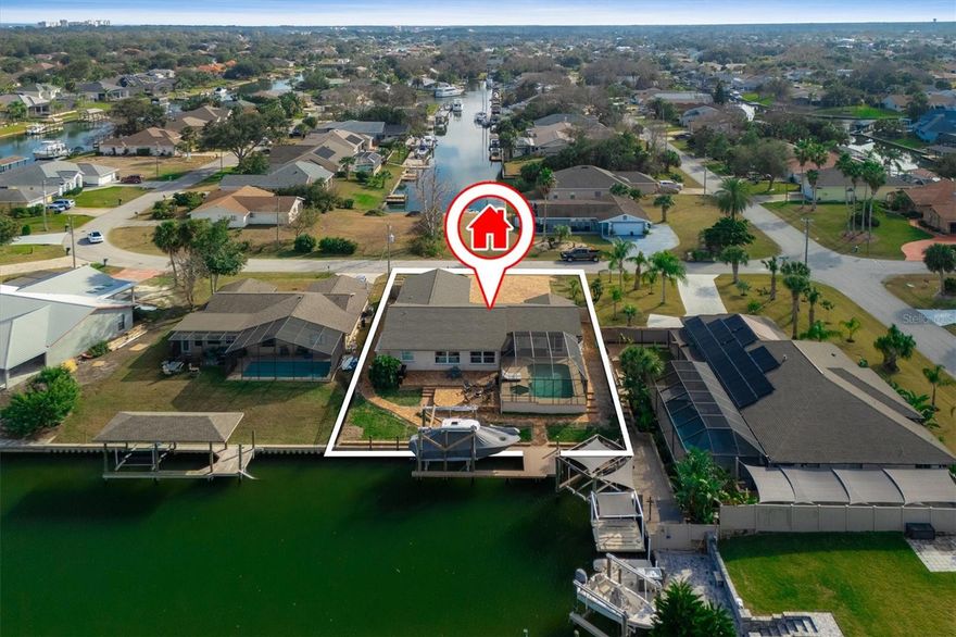 Experience the best of coastal living from this beautifully renovated waterfront home, ideally positioned on a deep-water saltwater canal with a brand-new private dock. With 2,134 square feet of thoughtfully designed living space, this 3-bedroom, 2-bath residence is both elegant and functional—offering luxury touches throughout, including a whole-house generator, commercial-grade ice maker, and a sparkling screened-in pool for year-round enjoyment. The private dock is a true boater’s dream, complete with 50-amp power service, water hookup, 30+ feet of decking, and a floating platform ideal for jet skis and kayaks.Inside, the heart of the home is the stunning open-concept kitchen featuring an oversized island—perfect for casual dining, entertaining, or culinary creations. Stylish tile backsplash, newer stainless-steel appliances, and sightlines to the great room enhance the airy, inviting ambiance. Walls of windows frame tranquil water views, bathing the space in natural light. Thoughtfully designed for versatility, the home offers multiple living areas. A cozy family room and a private office sit just off the entry, while the formal living and dining rooms provide refined spaces for gathering. The primary suite is a serene retreat, boasting sliding glass doors to the pool, dual walk-in closets, and a beautifully updated en suite bath with an expansive walk-in shower. Throughout the home, tile flooring delivers a seamless and elegant finish, while a side-entry two-car garage enhances both convenience and curb appeal. Enjoy the screened pool area or step out to the newly installed paver deck. Whether you're lounging by the pool, heading out for a day on the water, or entertaining in style, this property offers it all. Ideally located near I-95 for an easy commute and just minutes from pristine beaches, shopping, and fine dining. This is luxury coastal living—welcome home.
